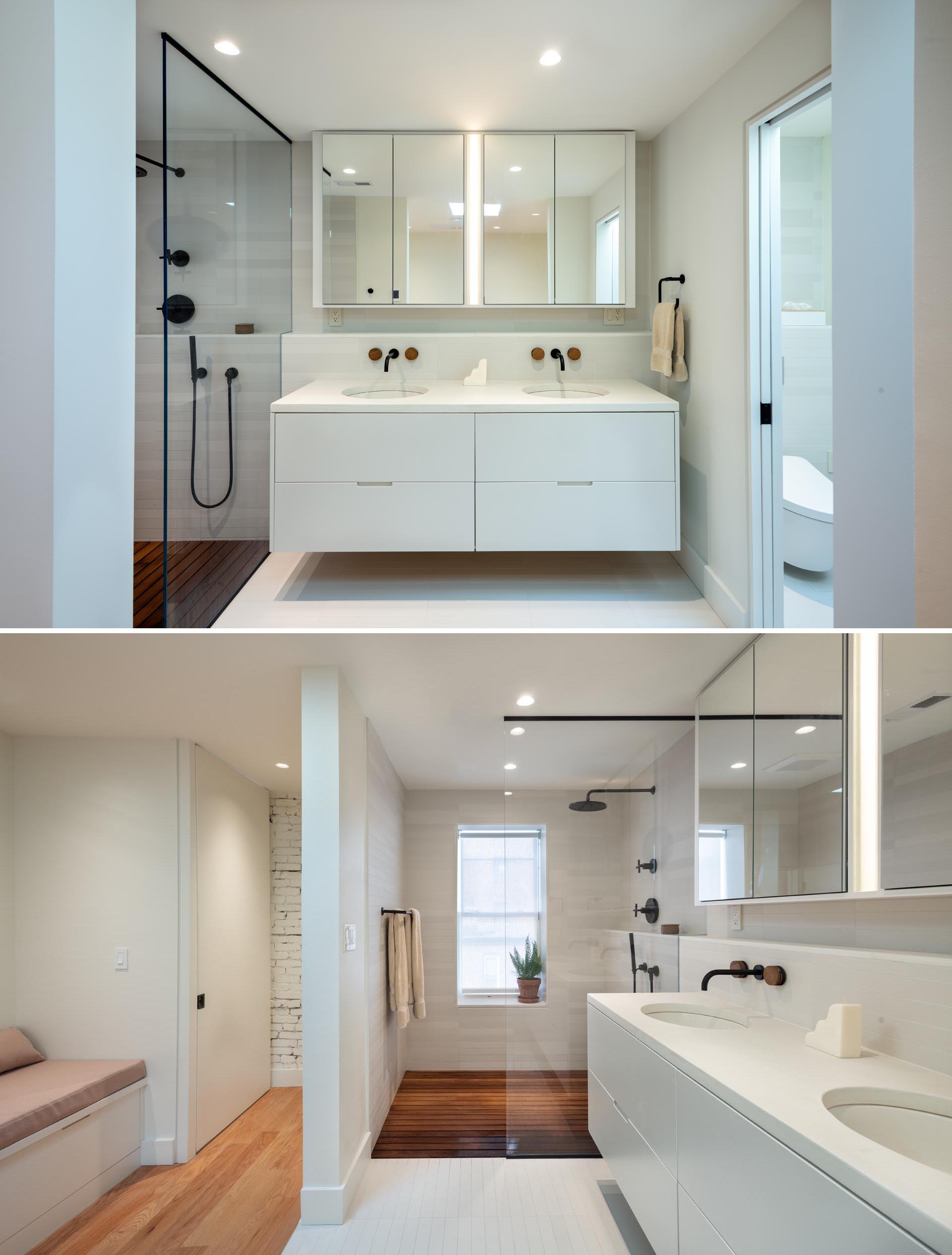 A modern bathroom with a floating white vanity, a walk-in shower with wood floor, and black accents.