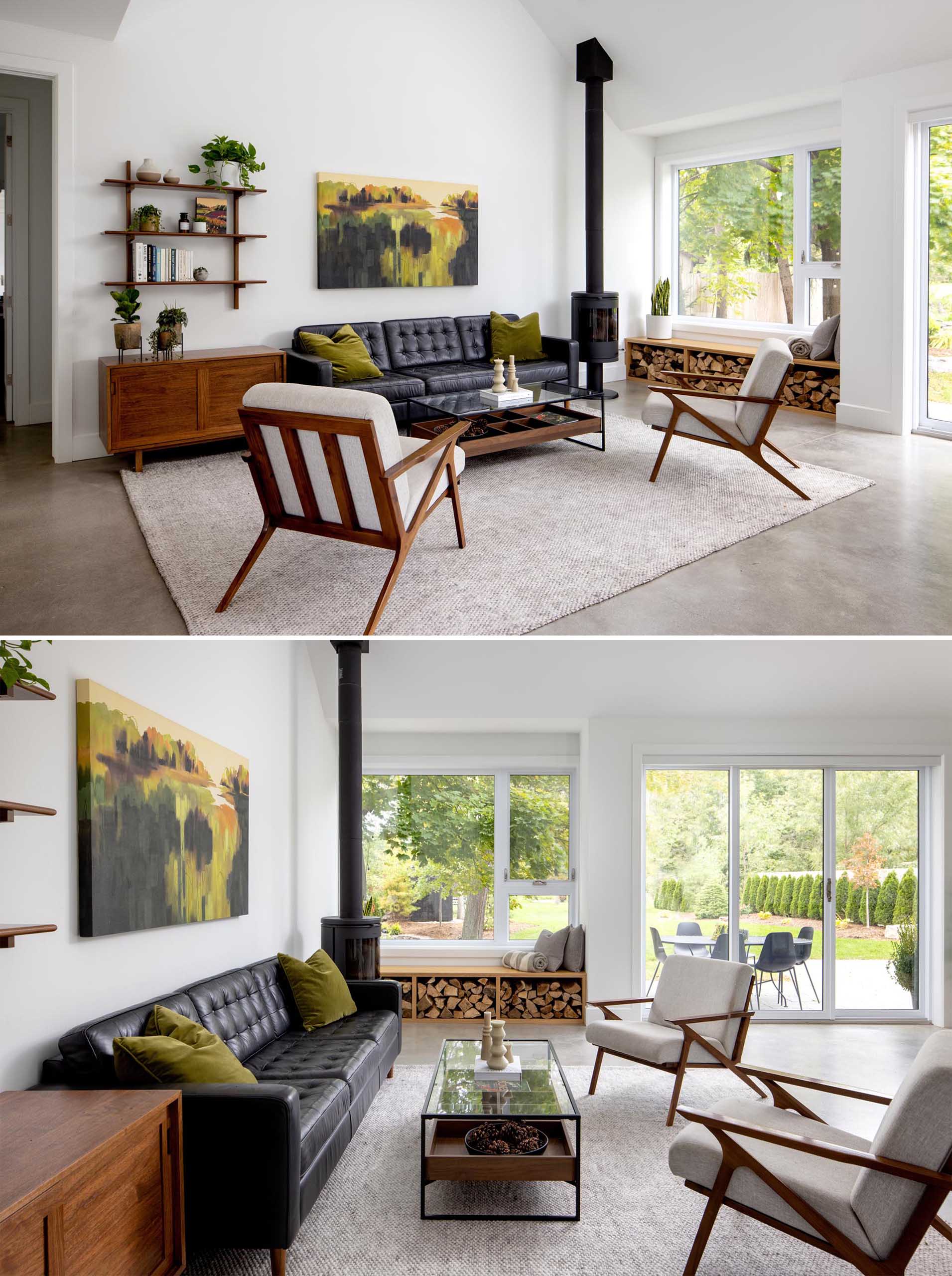 A modern living room with white walls, a black fireplace, and a window bench that includes firewood storage.