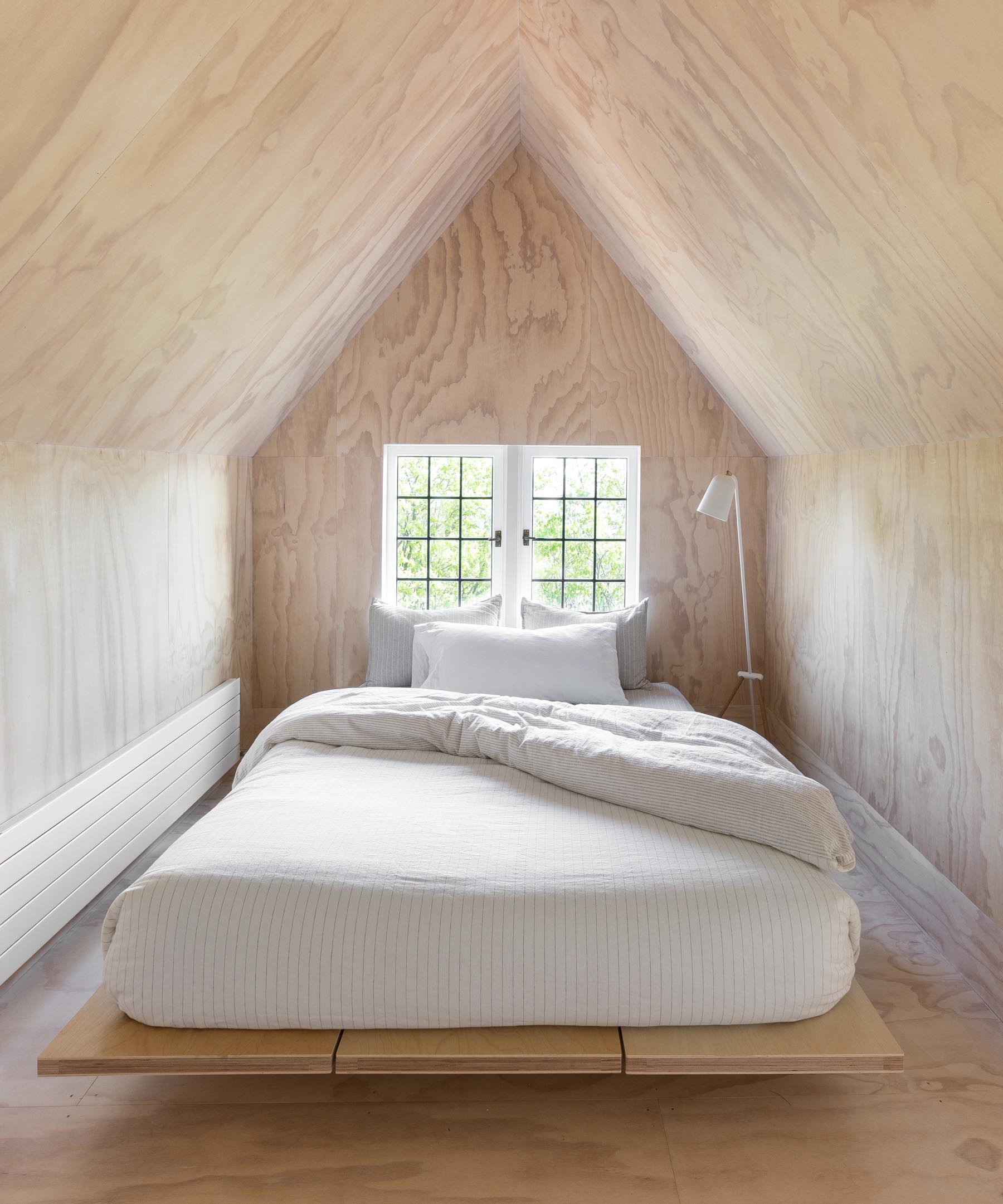 A contemporary plywood lined bedroom.