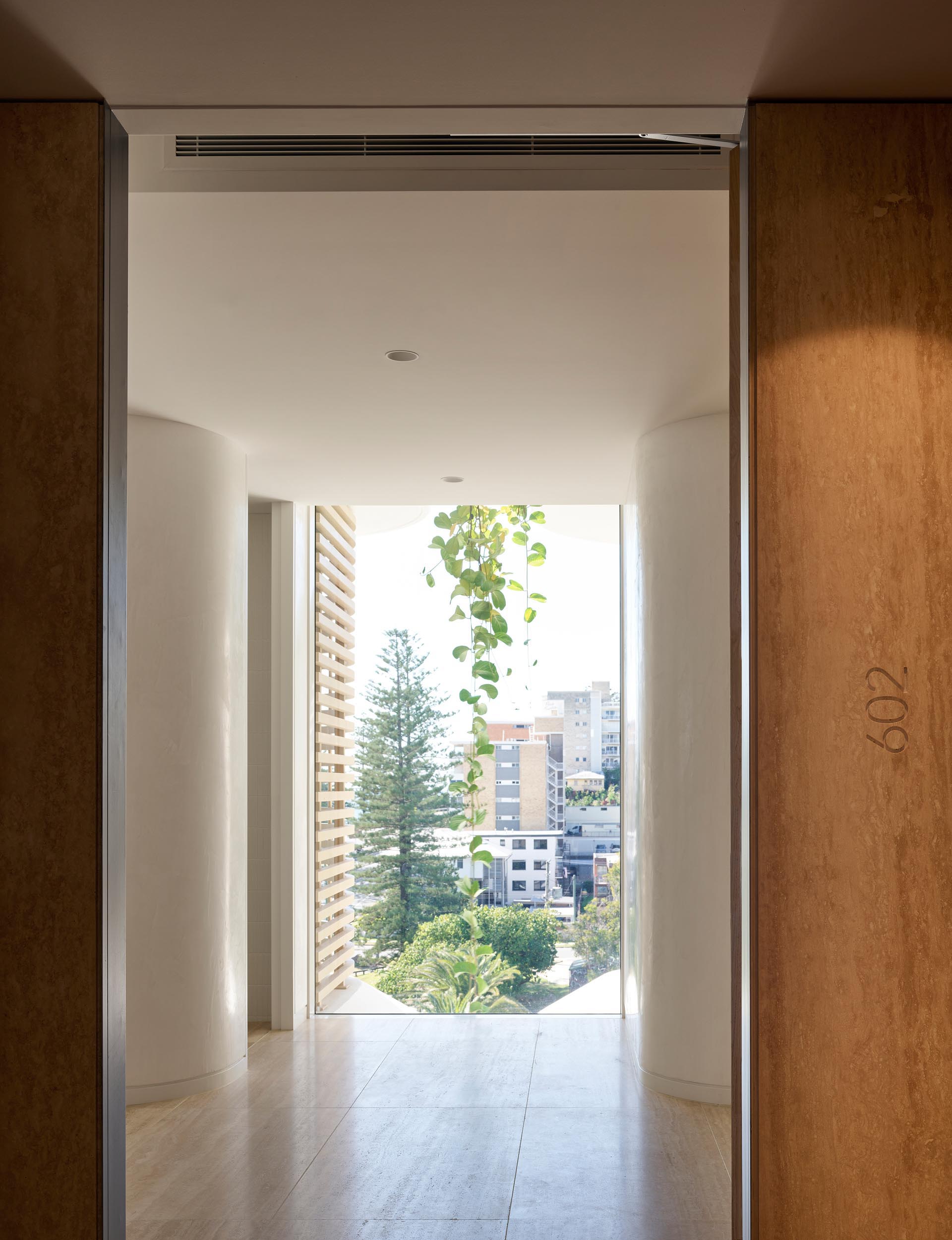 A modern apartment with a floor-to-ceiling window.