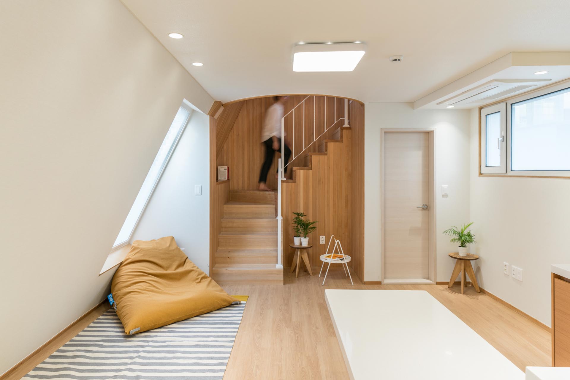 A modern apartment with a wood-lined stairwell.