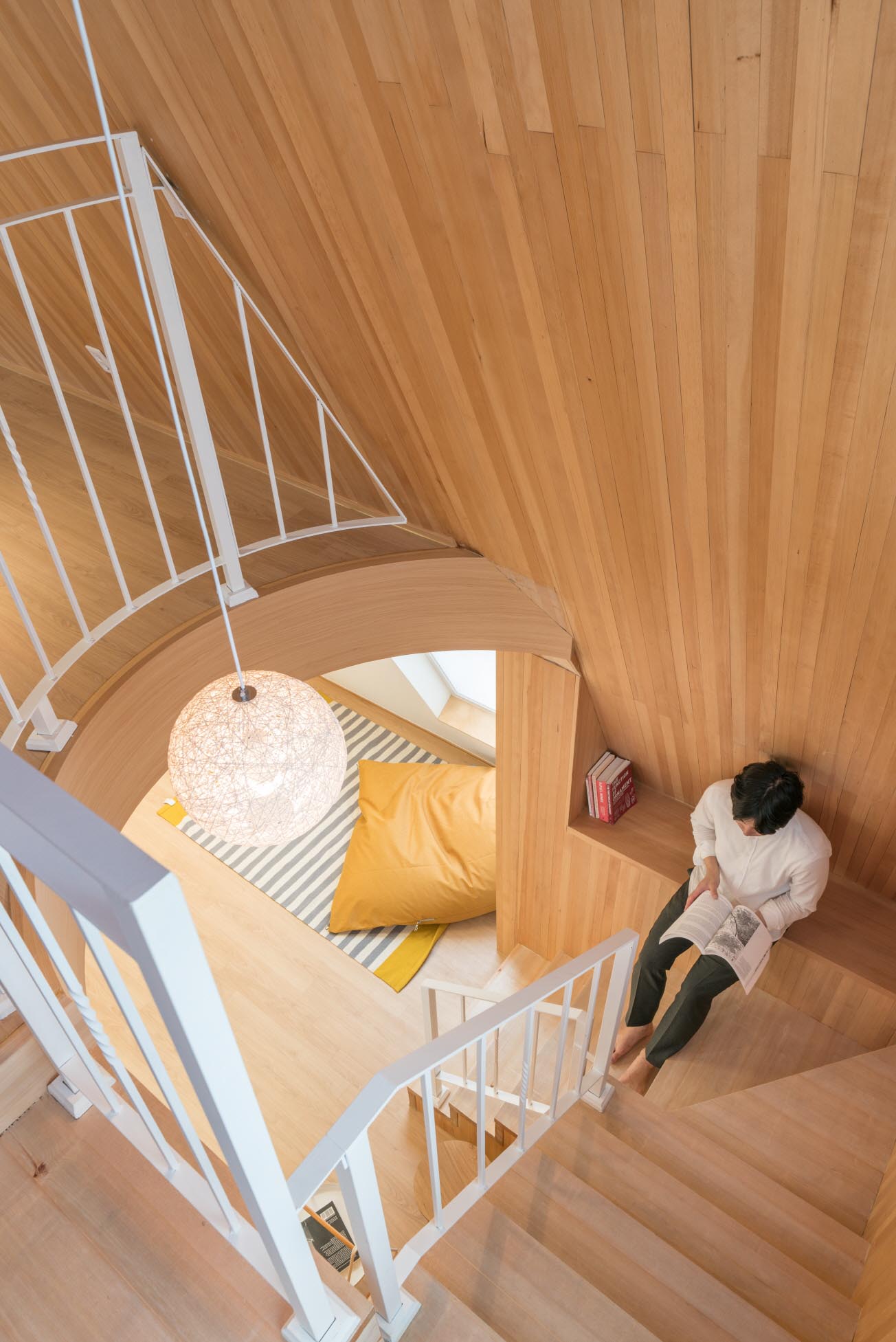 A modern apartment with a wood-lined stairwell.