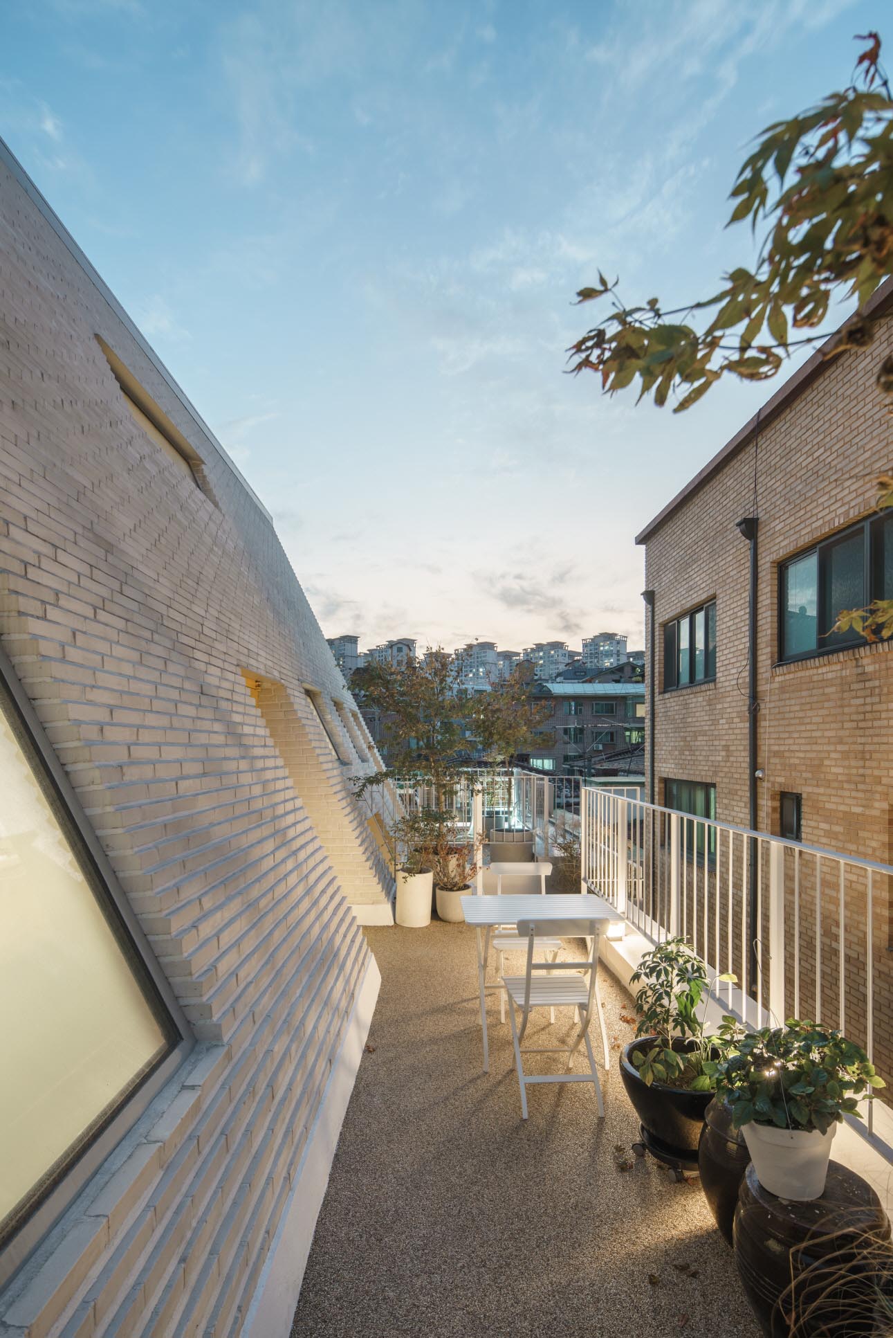 A modern balcony with a white railing.