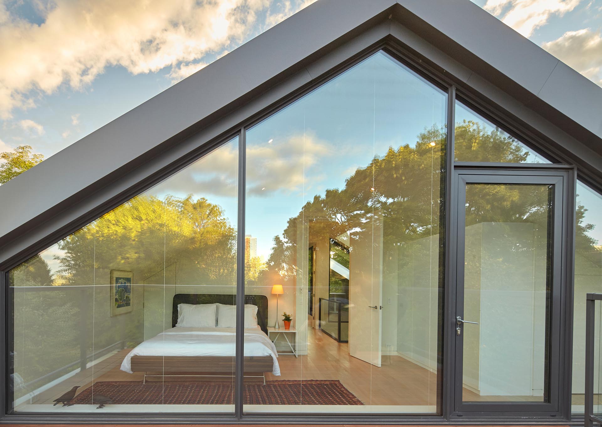 On the third floor, an exposed roof deck off a bedroom at the back of the house has plentiful views over the neighborhood and into the extensive green canopy surrounding the house.