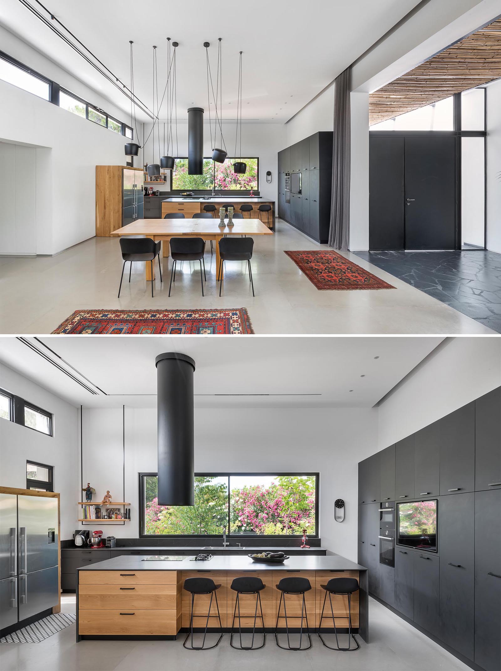 This modern kitchen includes minimalist black cabinets, black countertops, and wood accents.