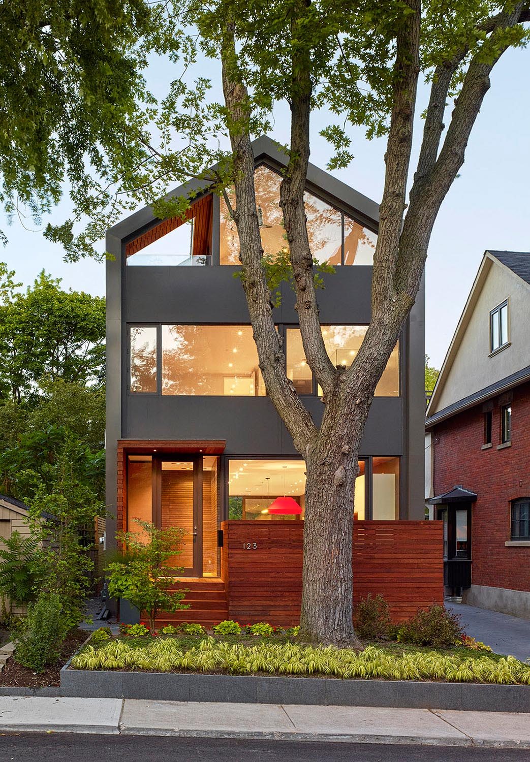 This modern house facade comprises of a combination of windows, doors and spandrel panels.