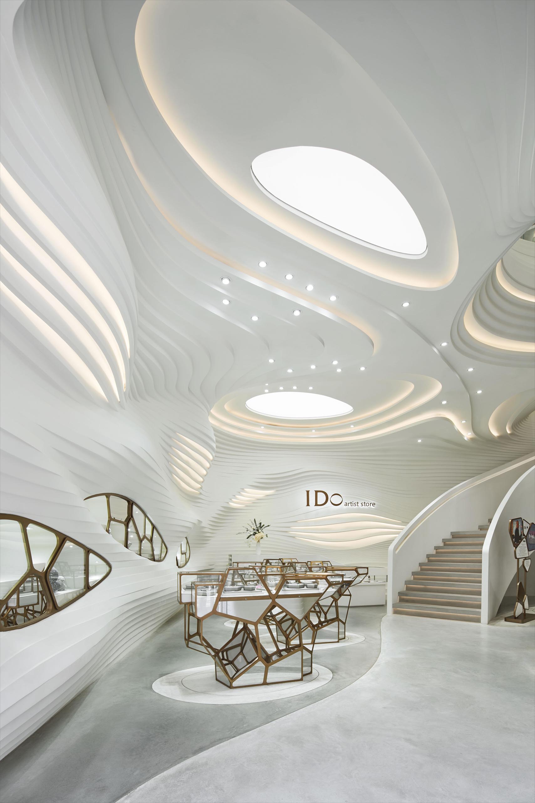 A modern retail store with an eye-catching facade, large sculptures, and a cave-like interior.