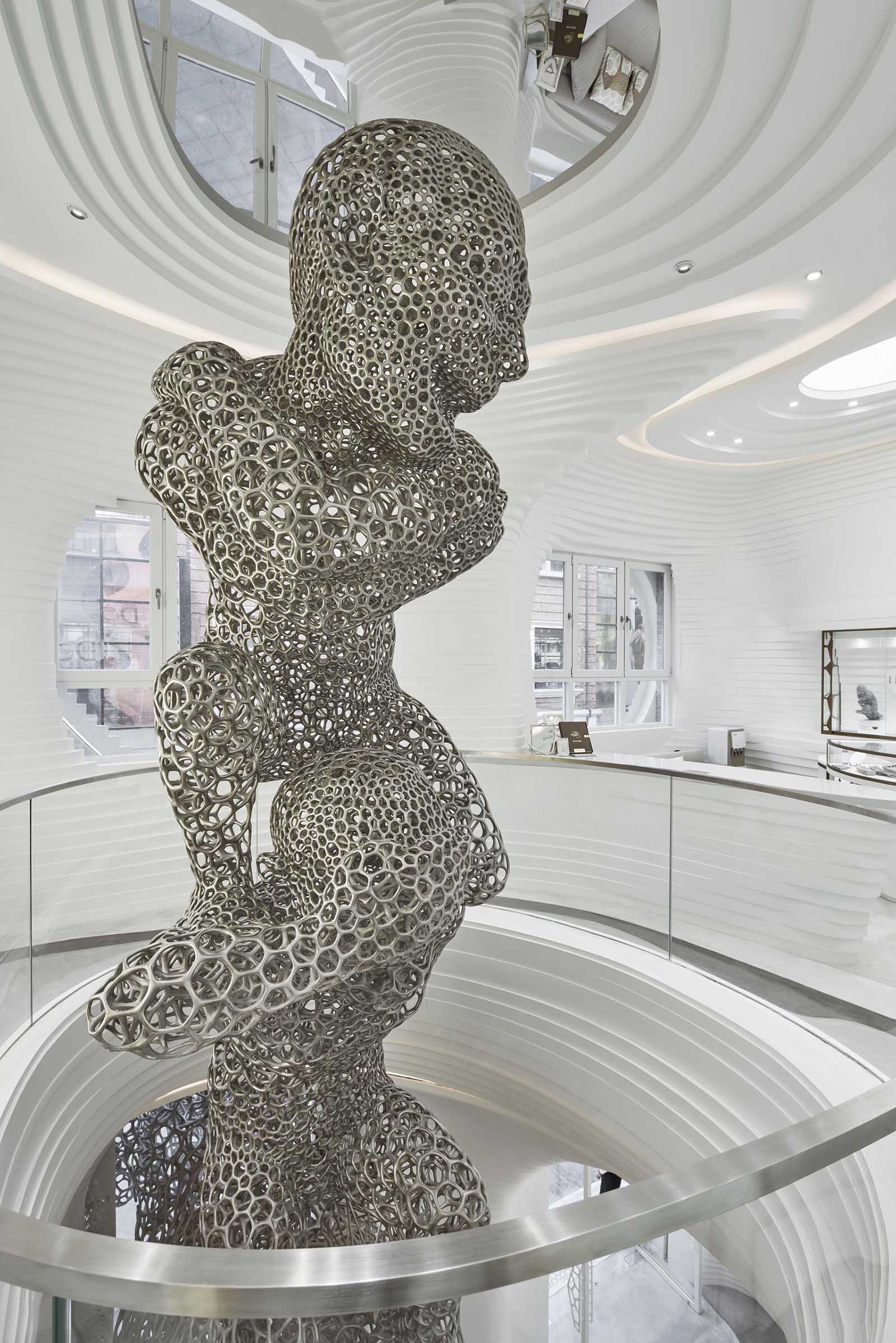 A modern retail store with an eye-catching facade, large sculptures, and a cave-like interior.