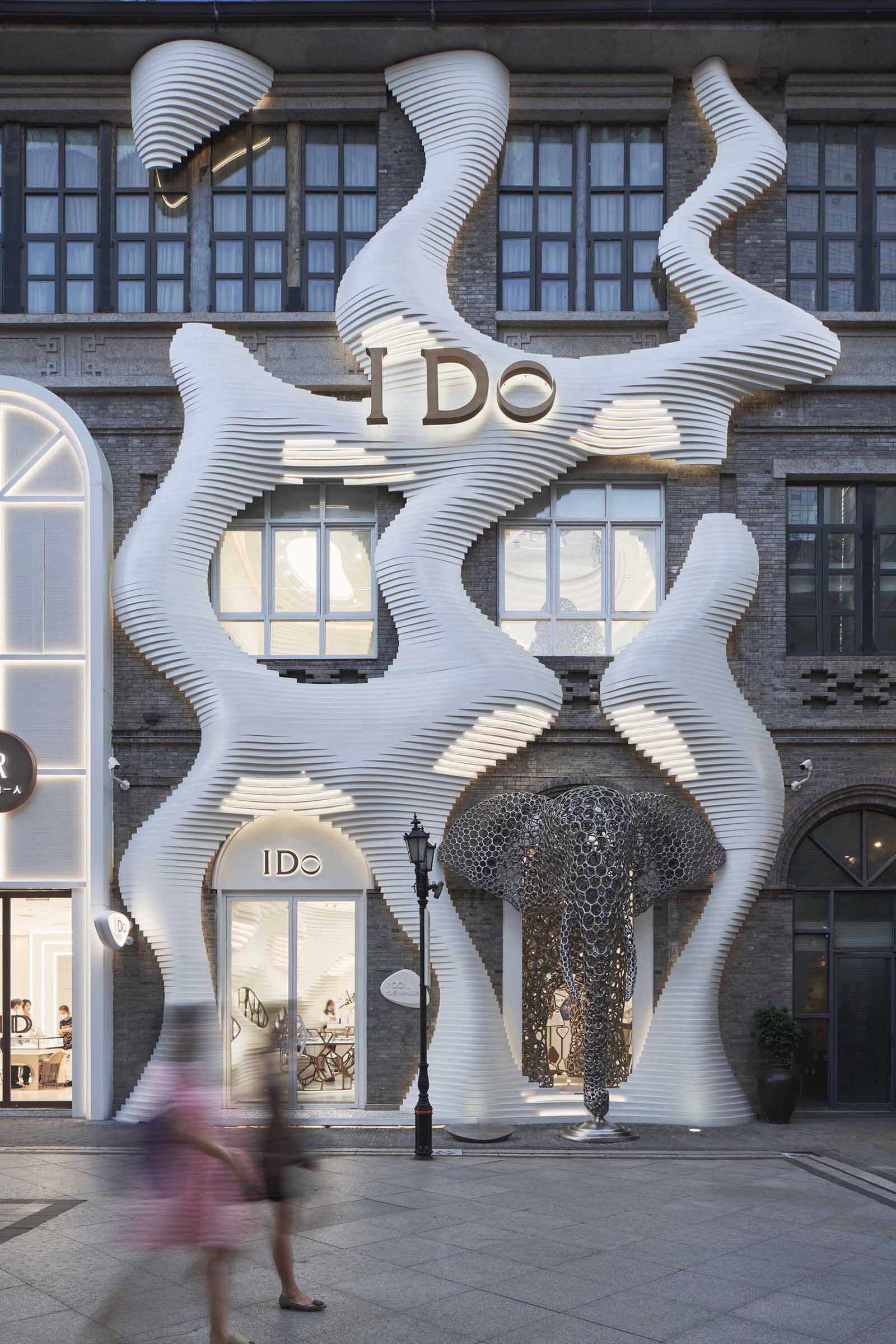 A modern retail store with an eye-catching facade, large sculptures, and a cave-like interior.