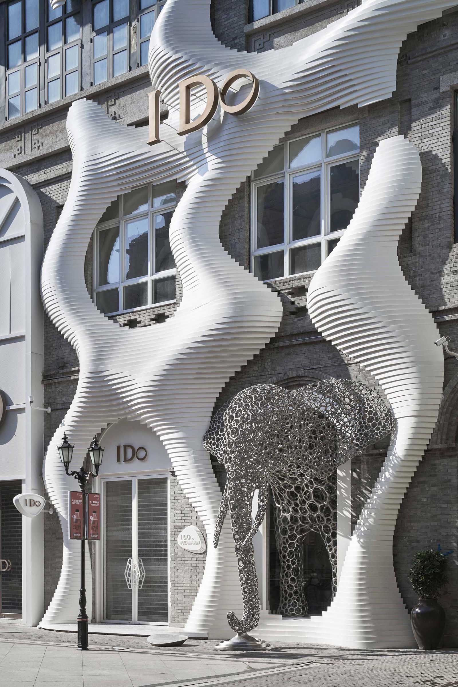 A modern retail store with an eye-catching facade, large sculptures, and a cave-like interior.