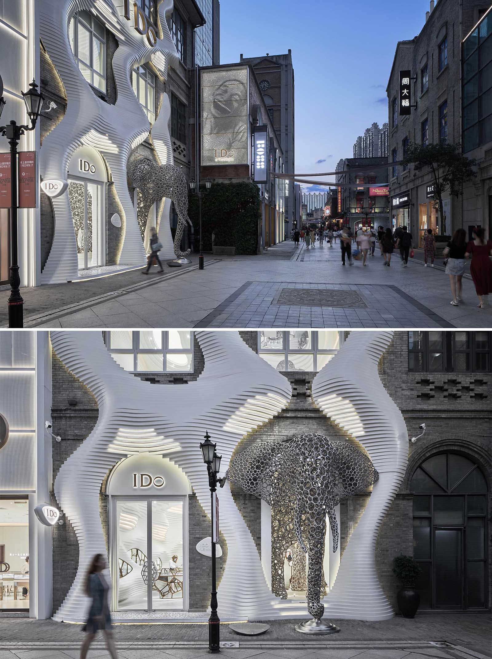 A modern retail store with an eye-catching facade, large sculptures, and a cave-like interior.