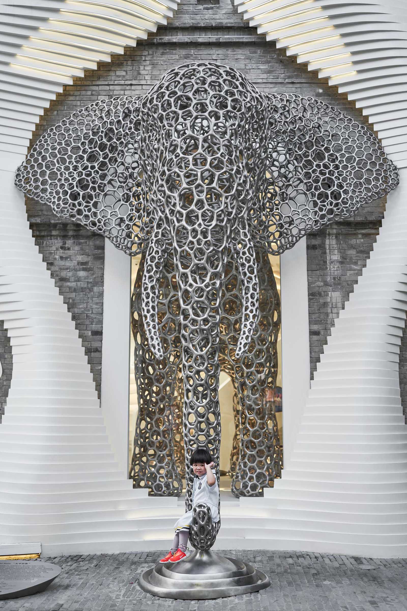 A modern retail store with an eye-catching facade, large sculptures, and a cave-like interior.