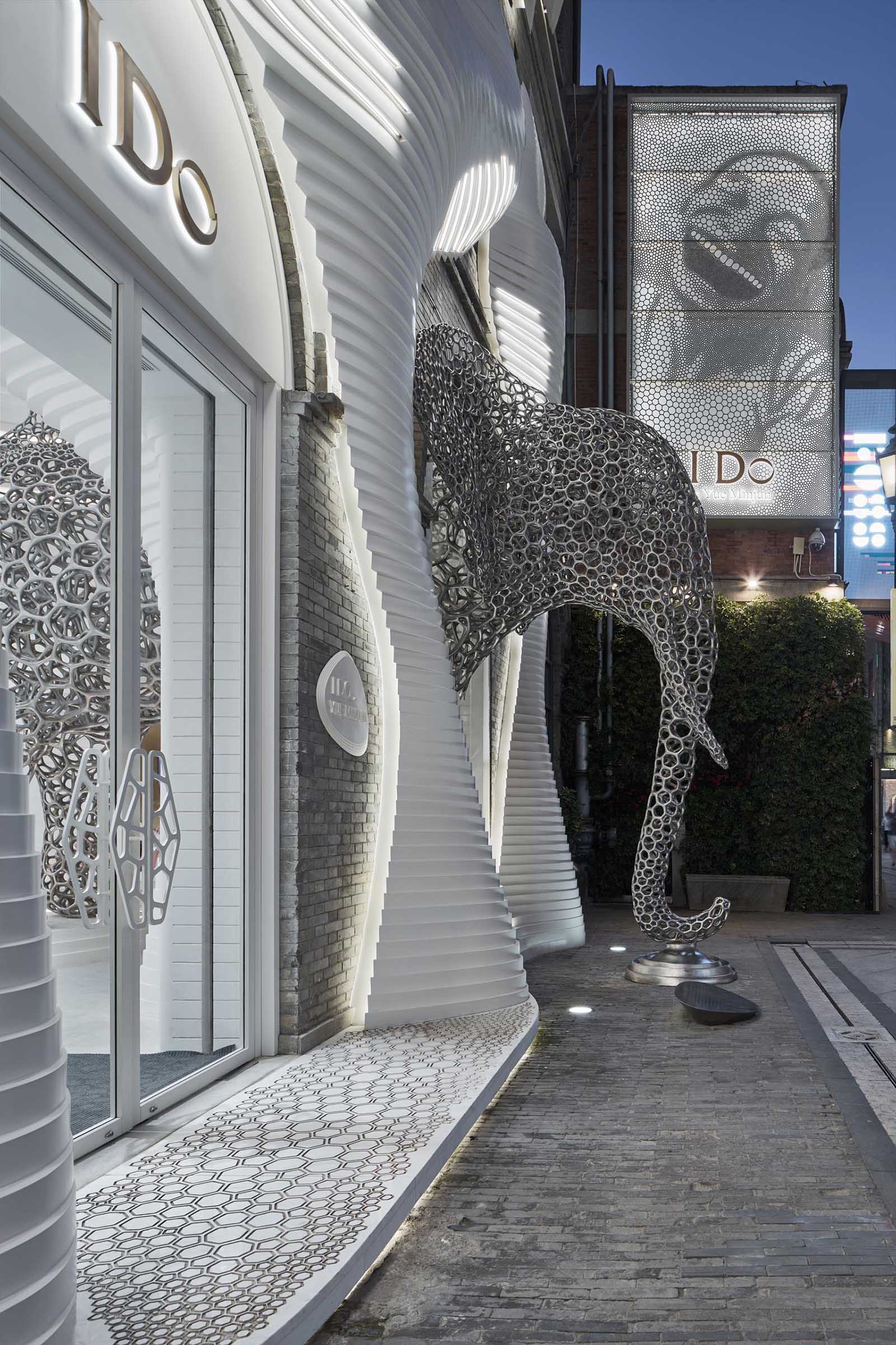 A modern retail store with an eye-catching facade, large sculptures, and a cave-like interior.