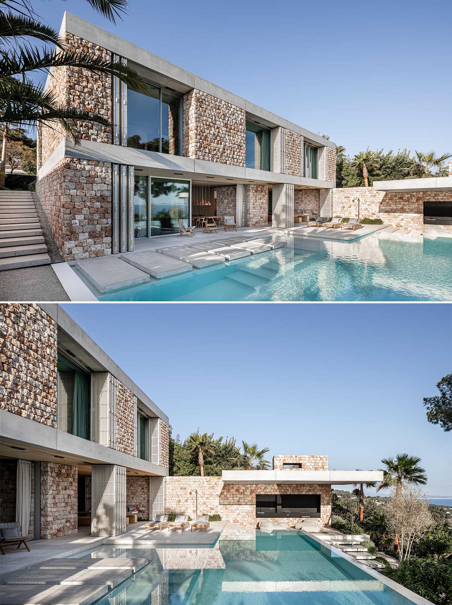 A modern stone house with an infinity edge swimming pool.