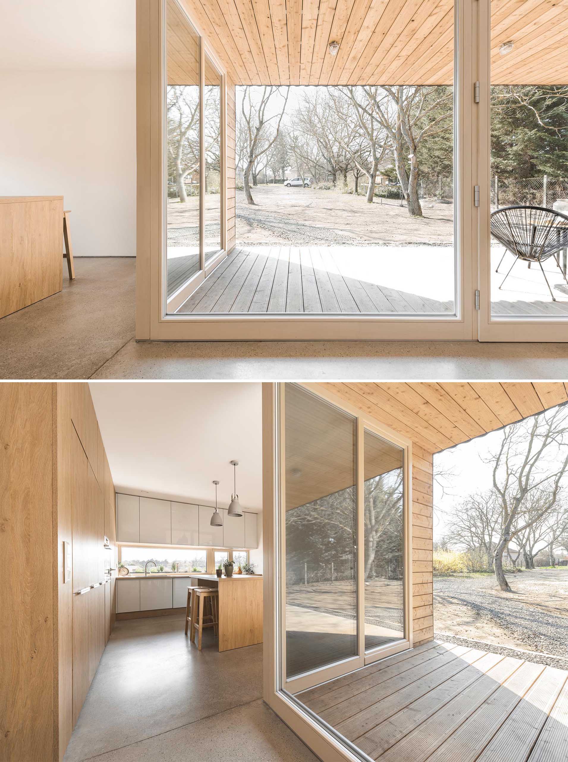 The interior of this modern home features simple white walls and a white ceiling, concrete floors, and a color palette of gray with yellow accents.