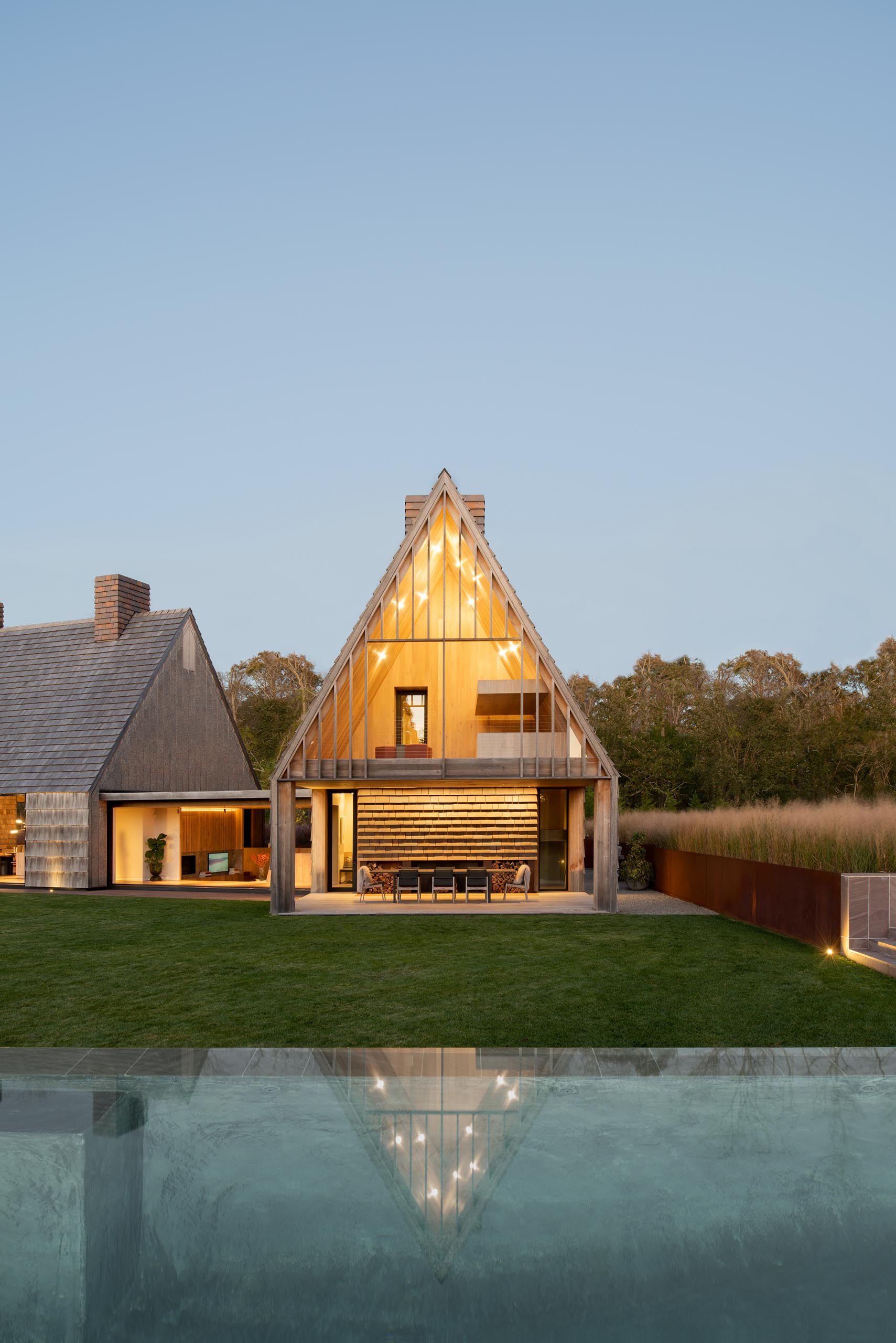 The exterior siding and paving of this modern house are carried through the breezeways that connect the volumes of the house, further integrating the house with the site.