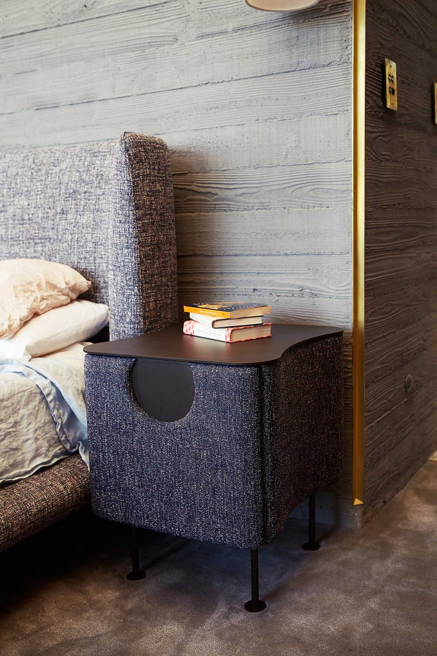 A modern bedroom with board formed concrete walls.