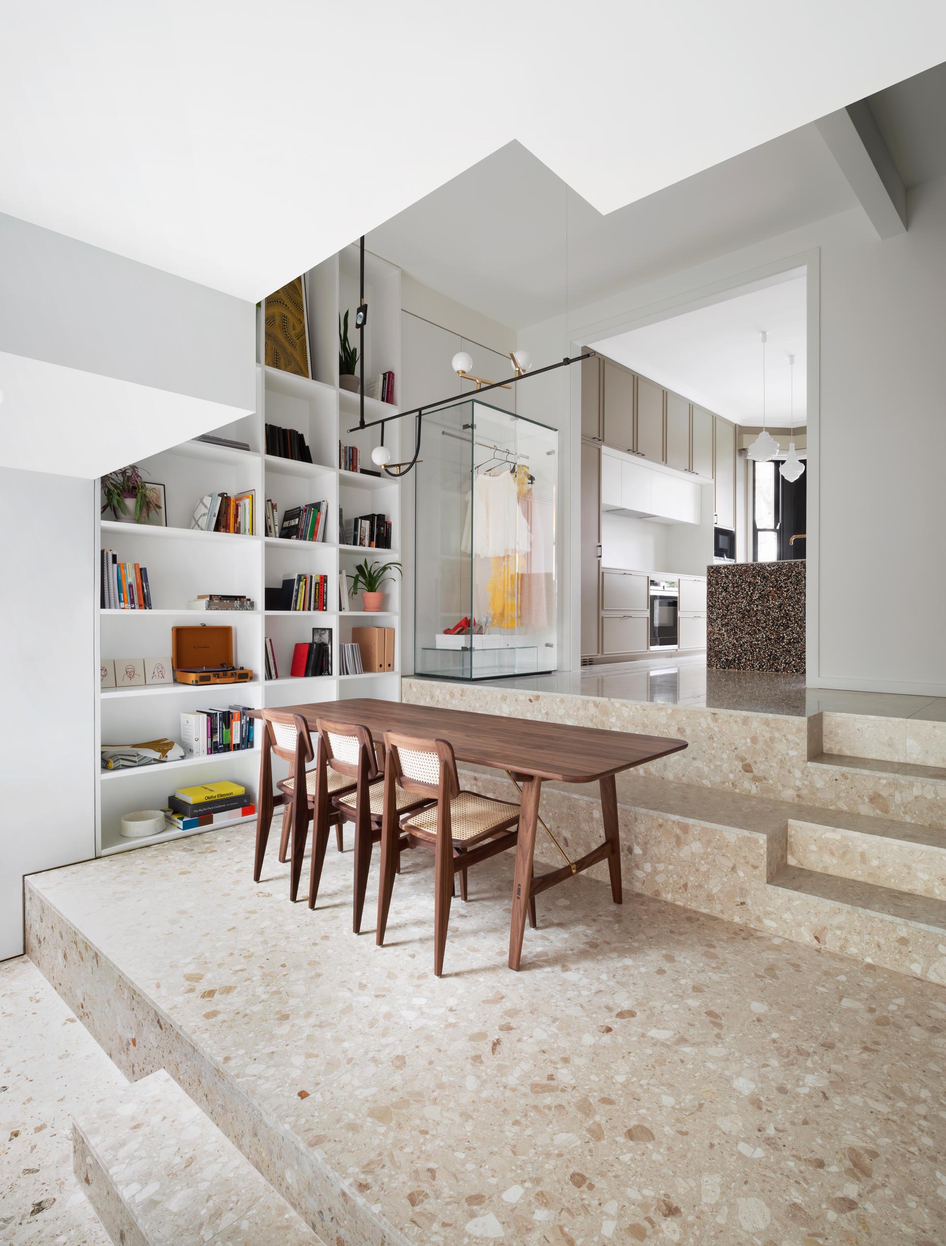 A modern dining area where the steps act as a bench for the dining table.