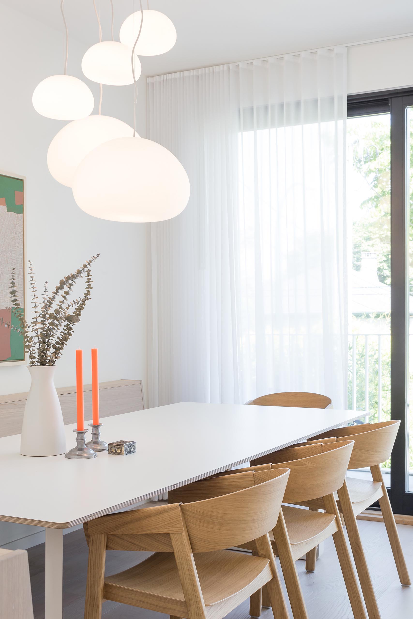 This modern dining area includes a built-in banquet bench that runs along the wall.