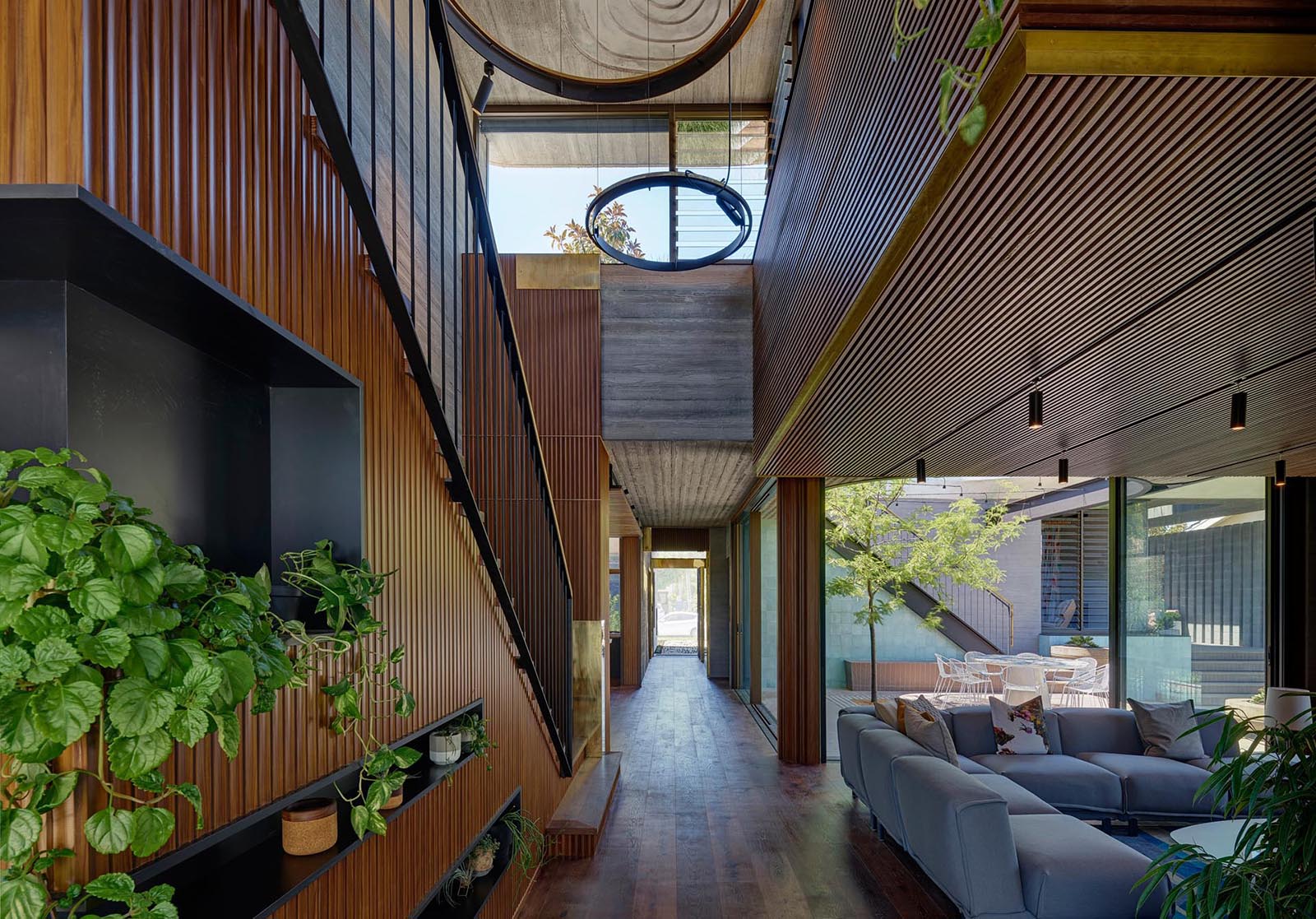 A modern home with wood detailing and board-formed concrete walls.