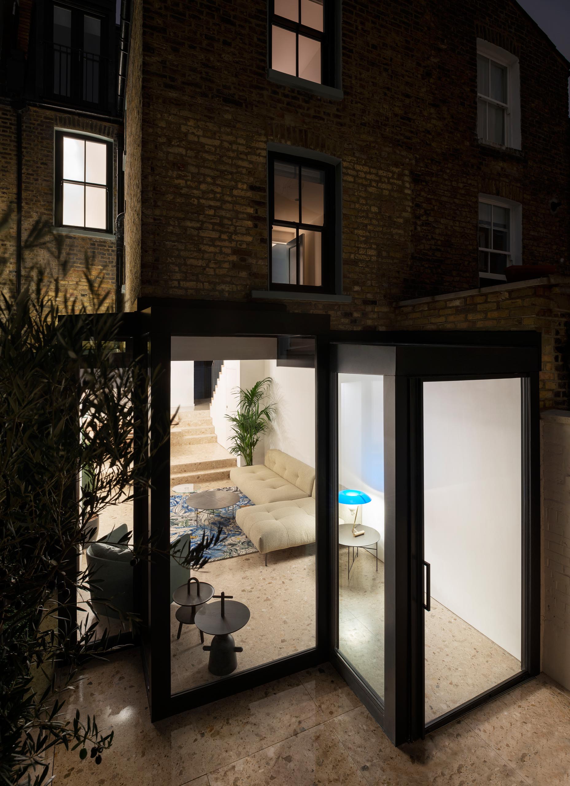 A modern house extension with thick black steel window frames.