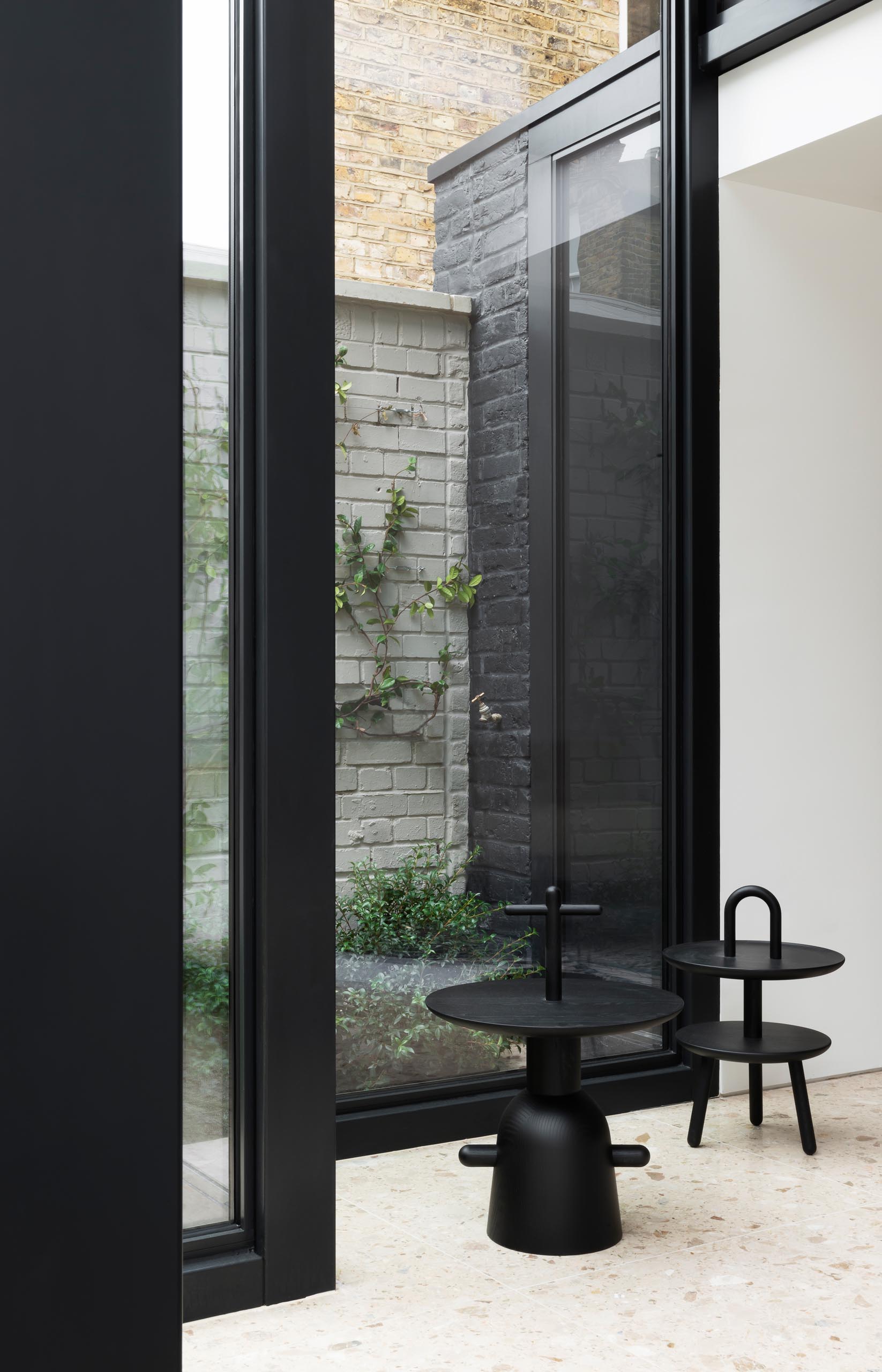 A modern house extension with thick black steel window frames.