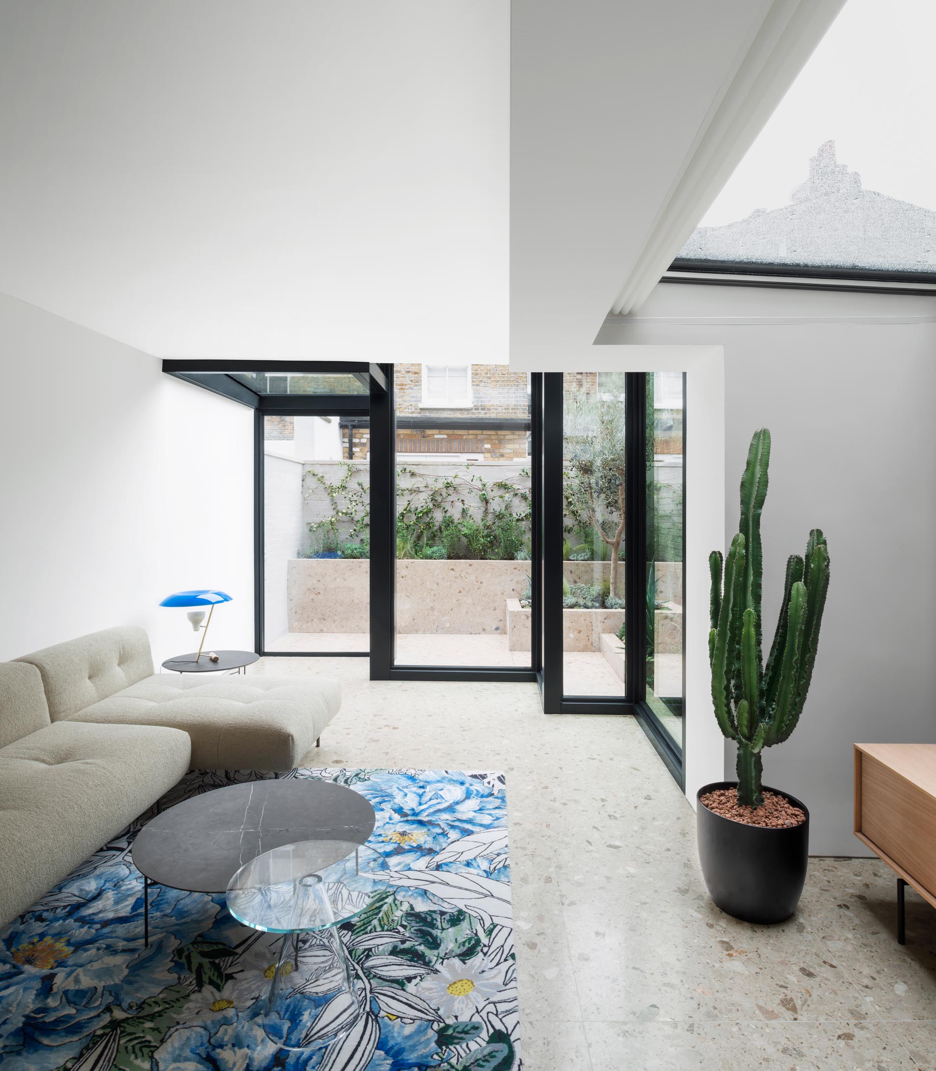 A modern house extension with Terrazzo flooring and thick black steel window frames.
