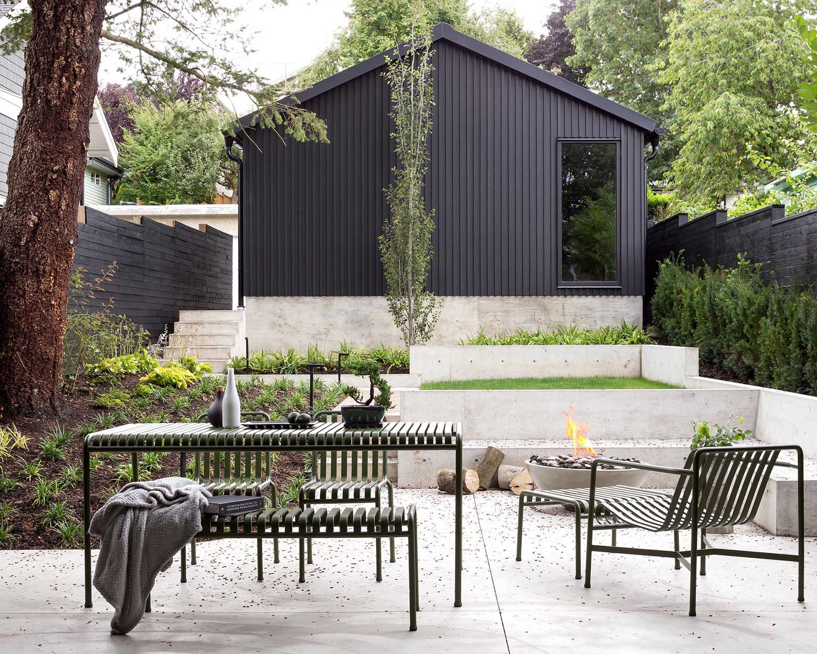 This modern terraced yard has a covered outdoor rear deck that's accessed via full width sliding doors from the family room.