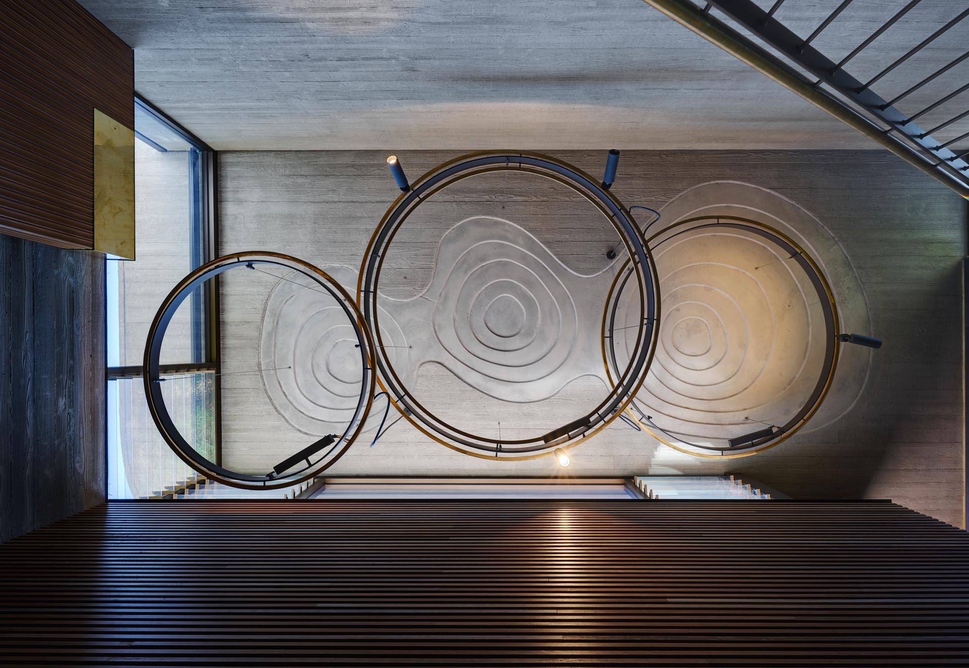 The concrete ceiling over the stair void in this modern home, has been designed with impressions representing the interlocking swamp lands of the area in which the house is located. 