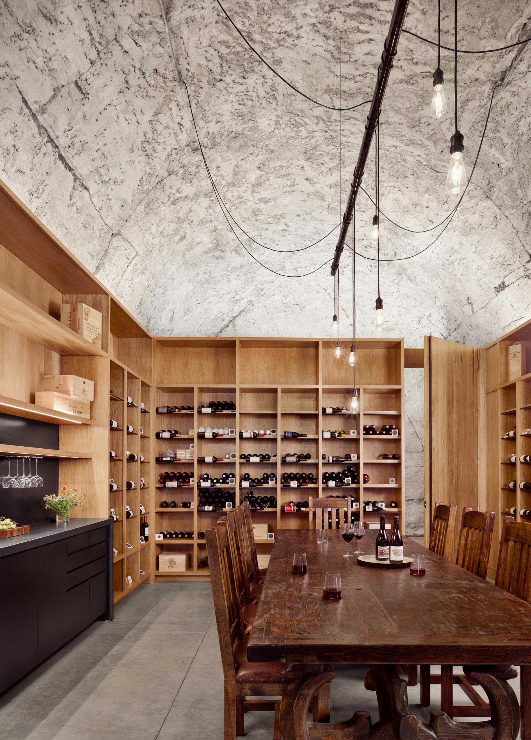 A private wine cave includes a tasting lounge, bar, wine cellar, and restroom.