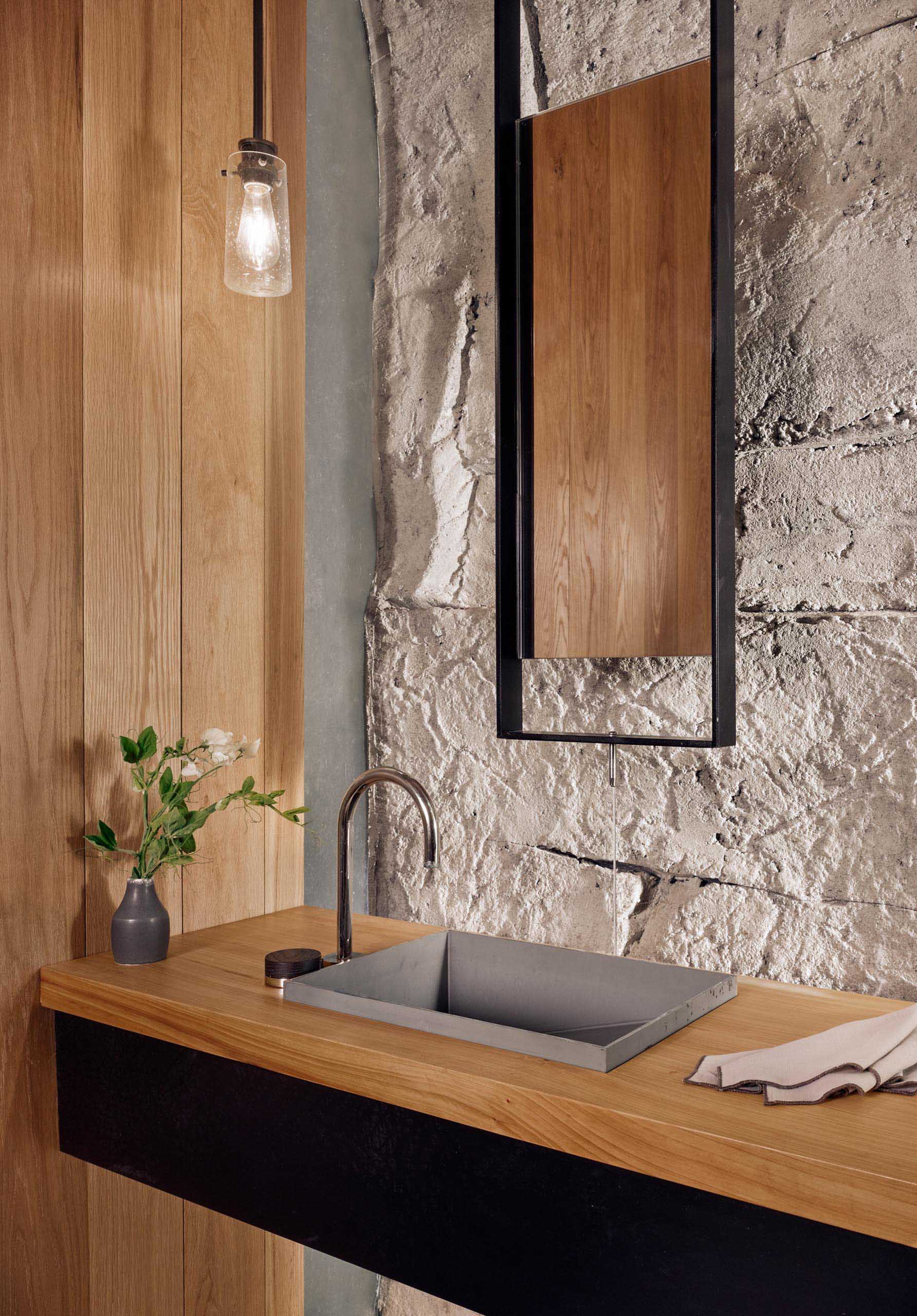 A bathroom with a floating vanity and hanging mirror.