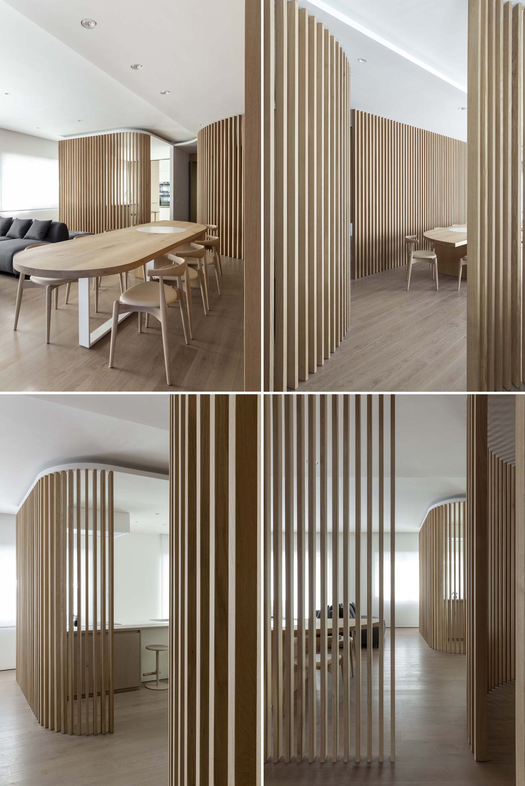 A modern apartment uses curved oak partitions to separate the kitchen from the living and dining room.