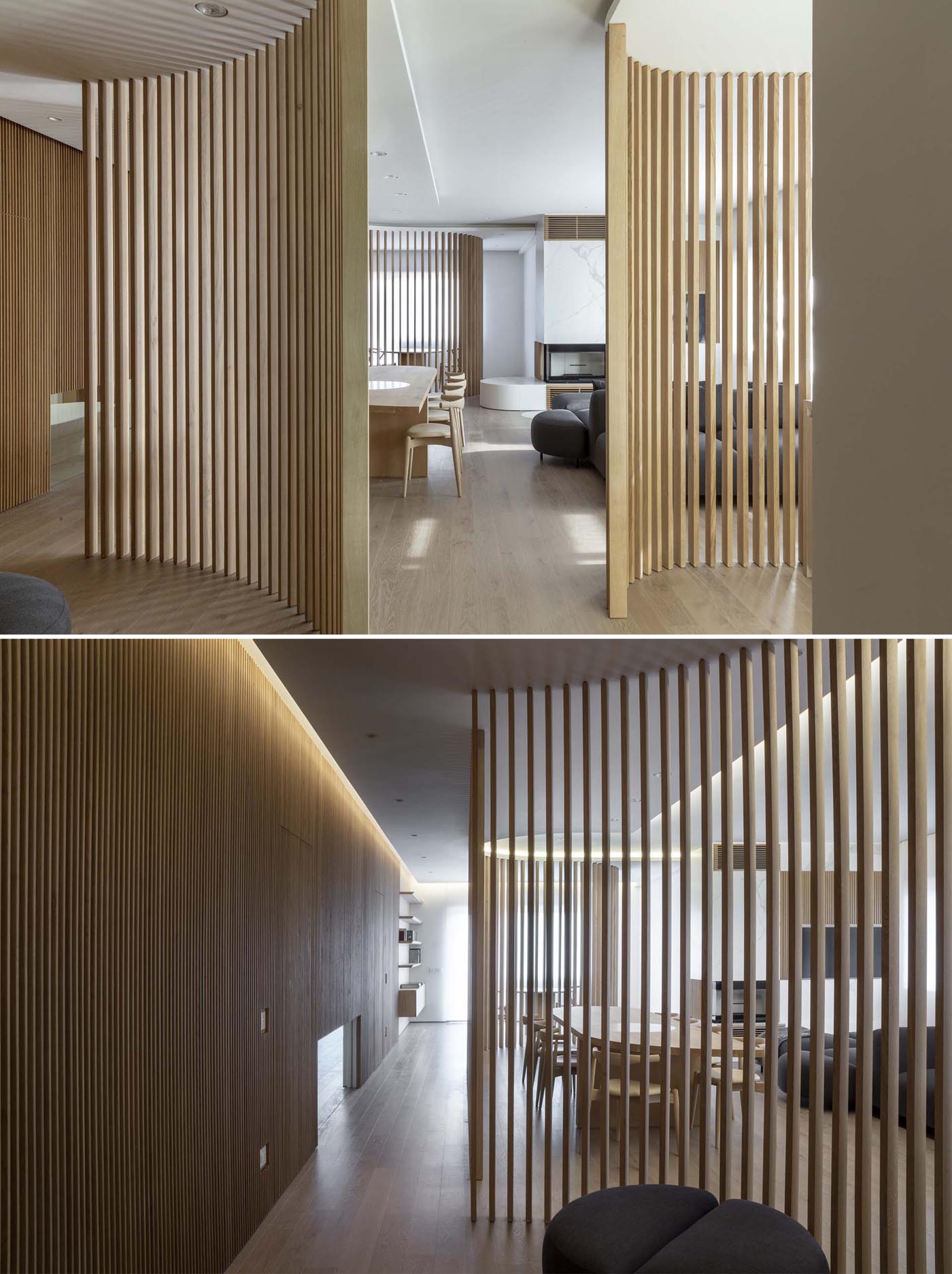 A modern apartment interior uses oak partitions to create zones for the living room, dining area, study, and kitchen.