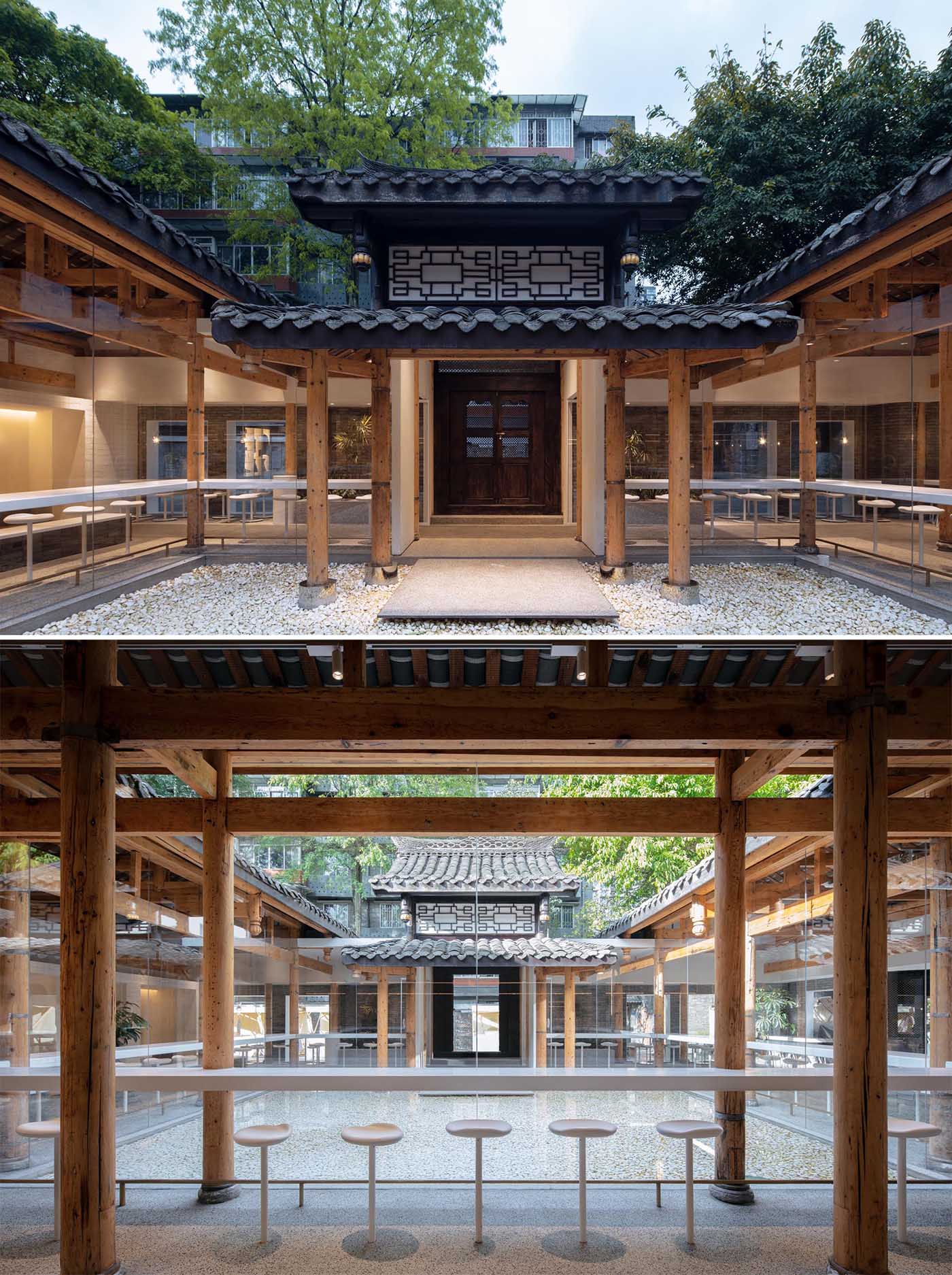 The black tile roof is a strong contrast to the interior that features walls of glass, a wood structure and white accents.