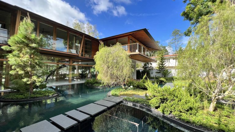 Bridges Connect To An Island In The Water-Filled Courtyard Of This Home In Singapore