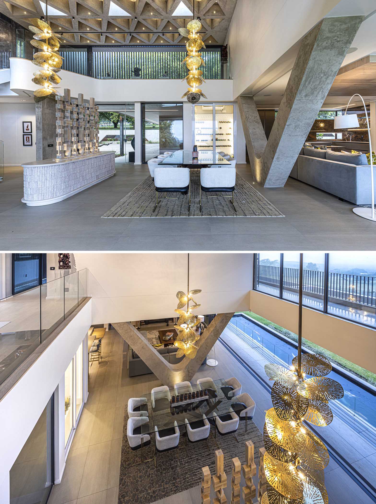 This modern house has an open plan dining area and built-in wine cellar. Sculptural lighting elements add an artistic touch to the space.