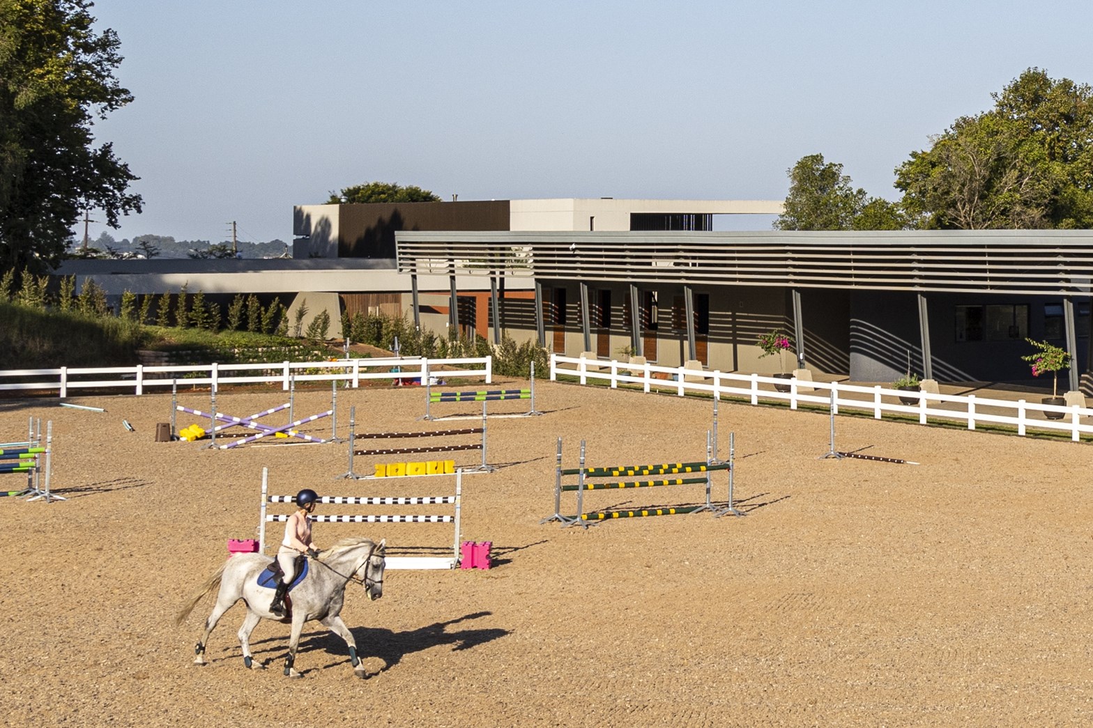 A modern home estate with an equestrian field.
