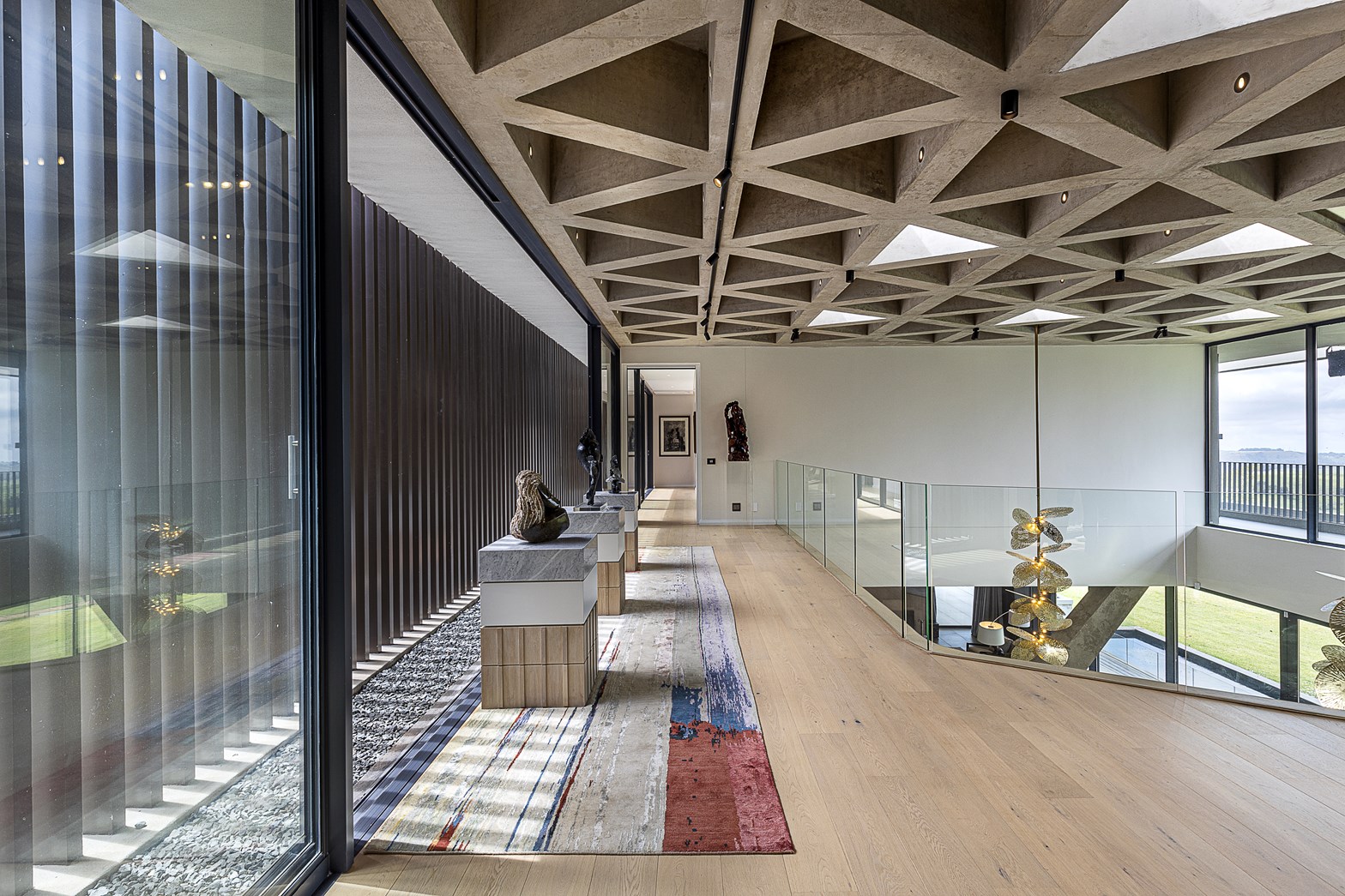 A modern open plan hallway with wood flooring.