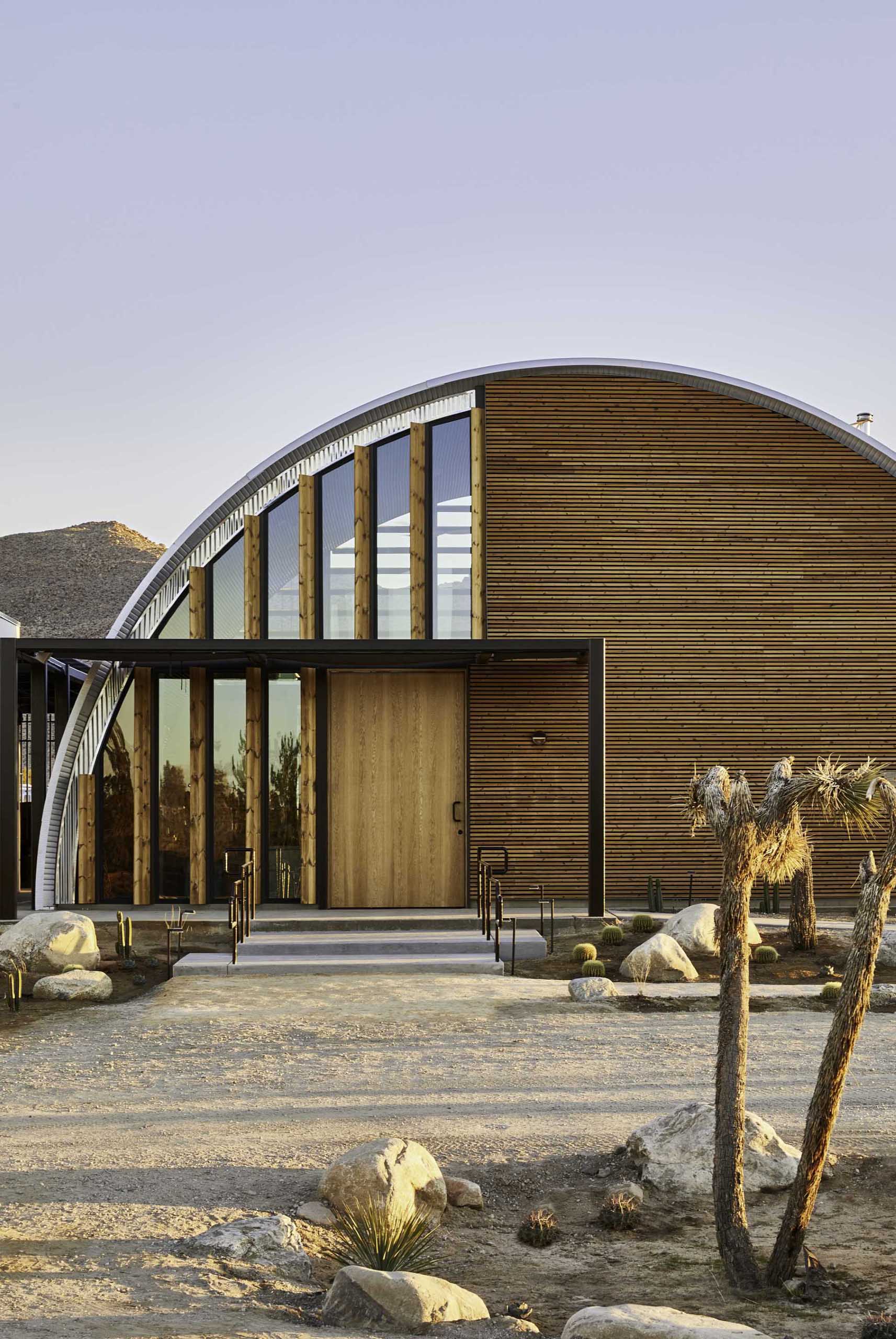 The architects chose to use raw and natural materials on this Quonset Hut inspired Clubhouse, which will weather in place and improve with age as they blend into the natural landscape.