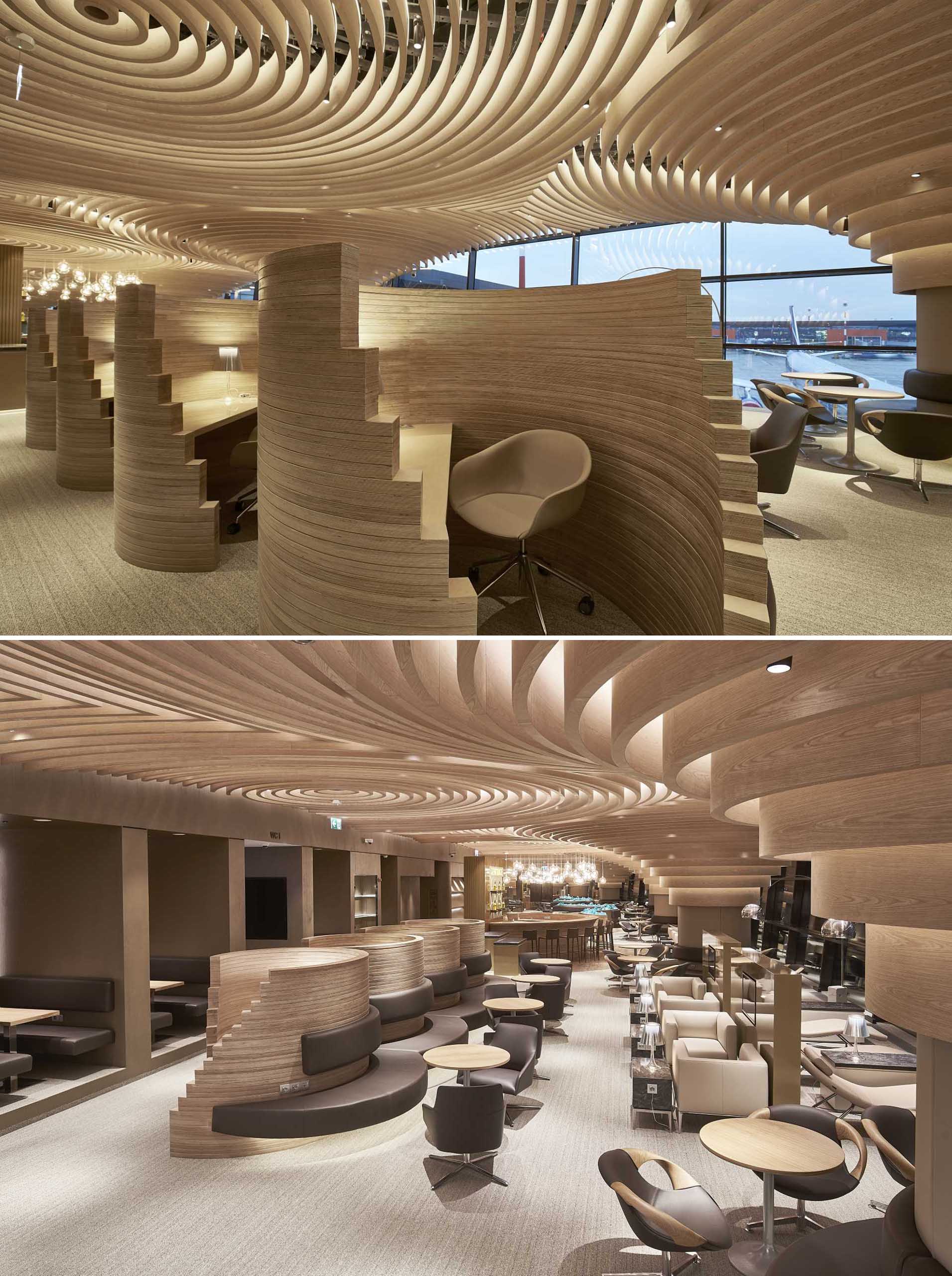 A sculptural wood ceiling spreads over various seating areas of this airport lounge.