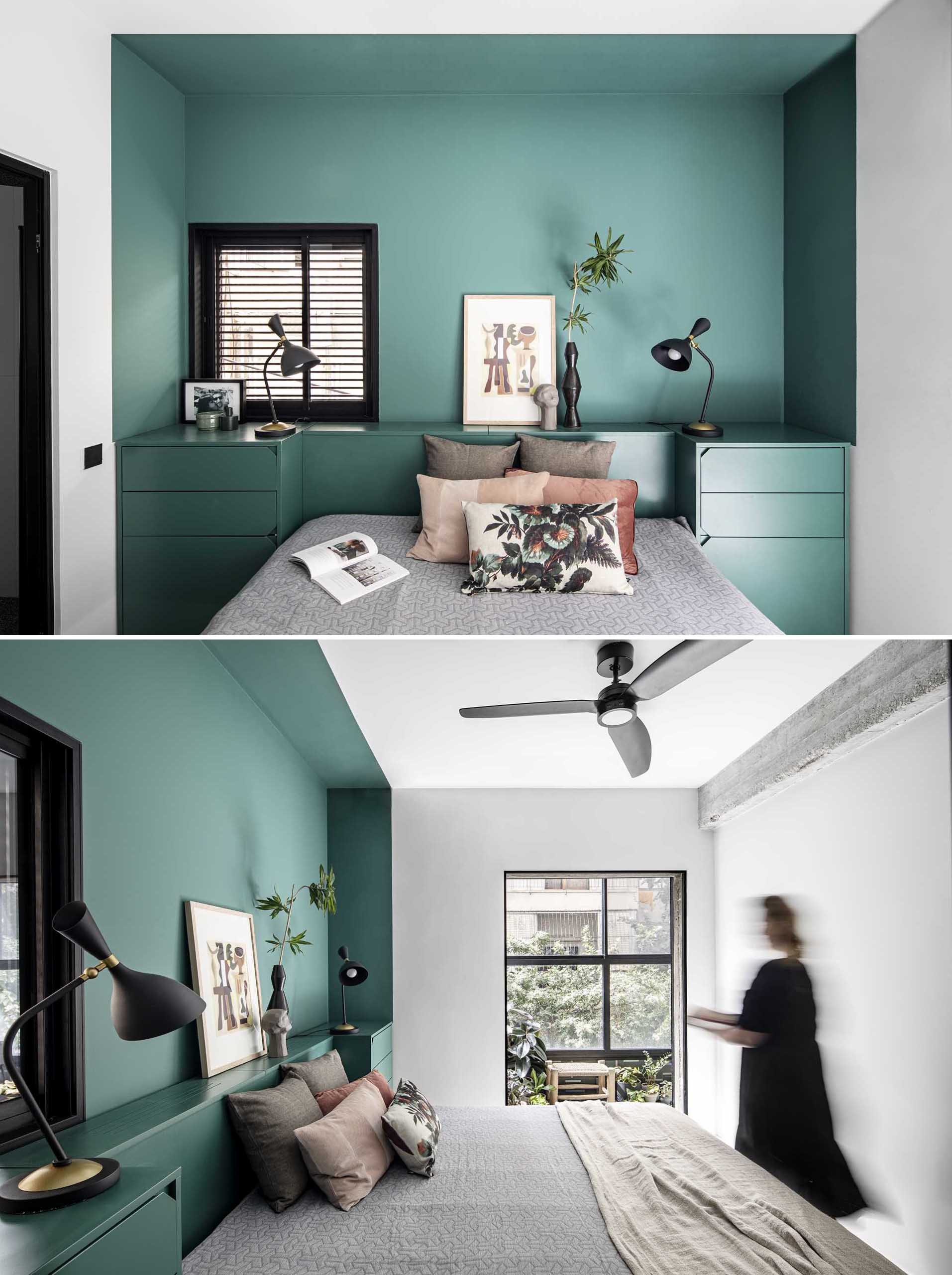 The primary bedroom has an evergreen-colored accent wall that also includes the bedside storage units and the framing of the bed, creating a cohesive look.