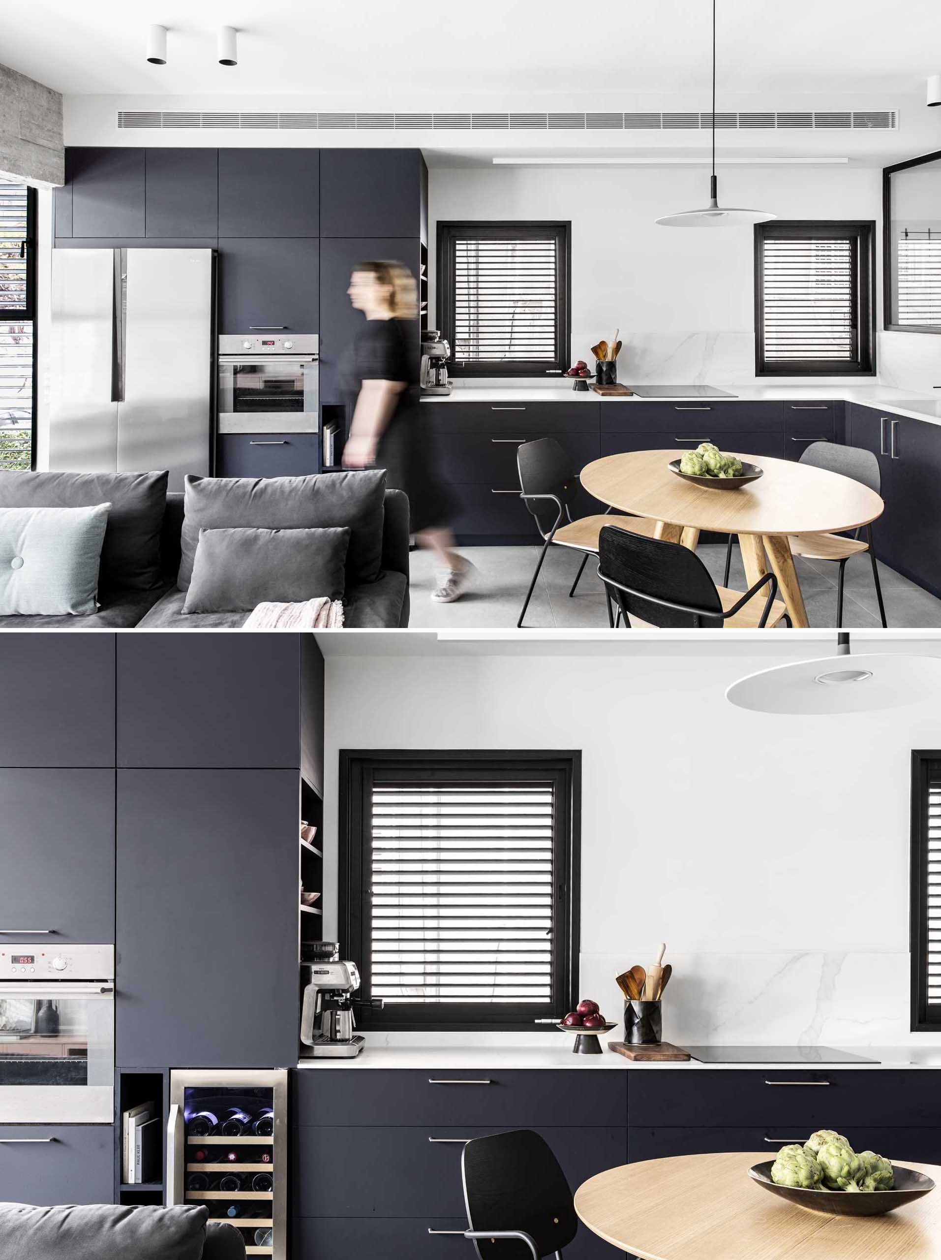 A modern L-shaped kitchen with matte black cabinets.