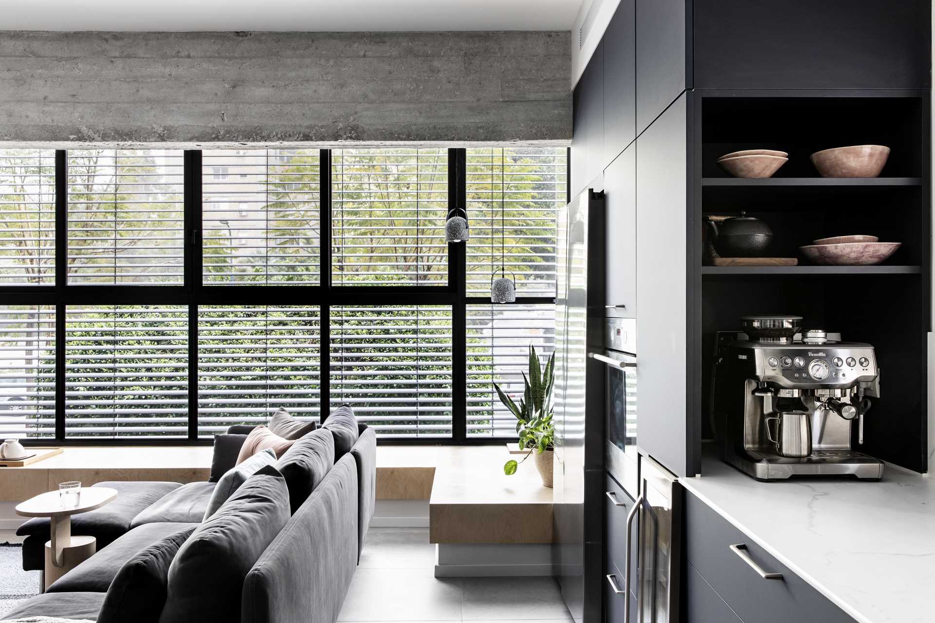 A modern living room with a large window bench for extra seating.