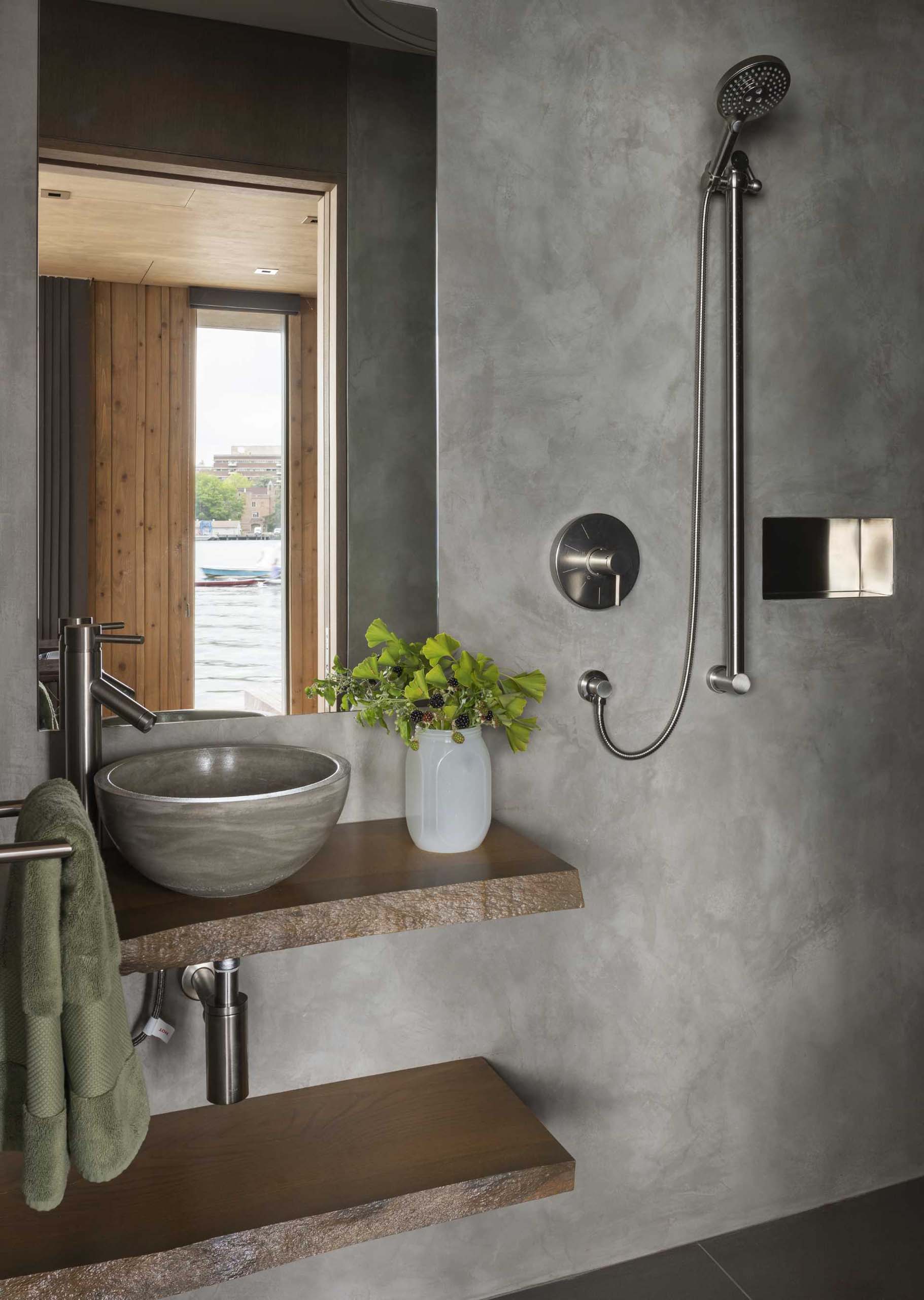 A modern bathroom with a live-edge floating wood vanity and shelf.