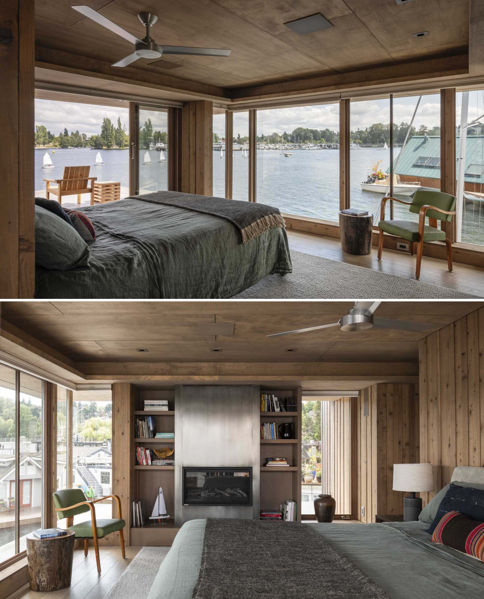 This primary bedroom includes floor-to-ceiling windows and sliding doors, as well as a fireplace and built-in shelving.