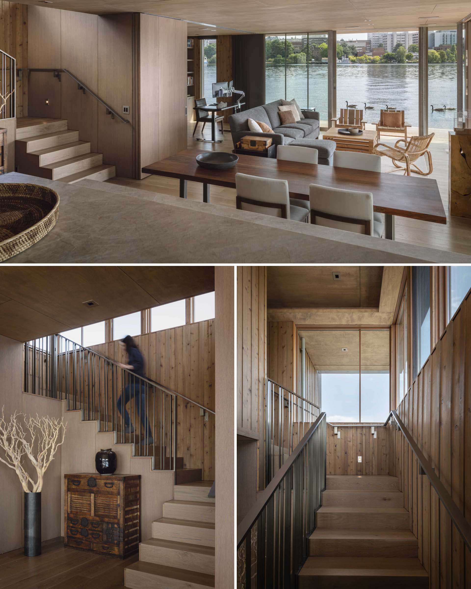 The staircase to the second level  of this modern floathome, includes knotty wood wall finishes, and acts as a lightwell to capture natural daylight.