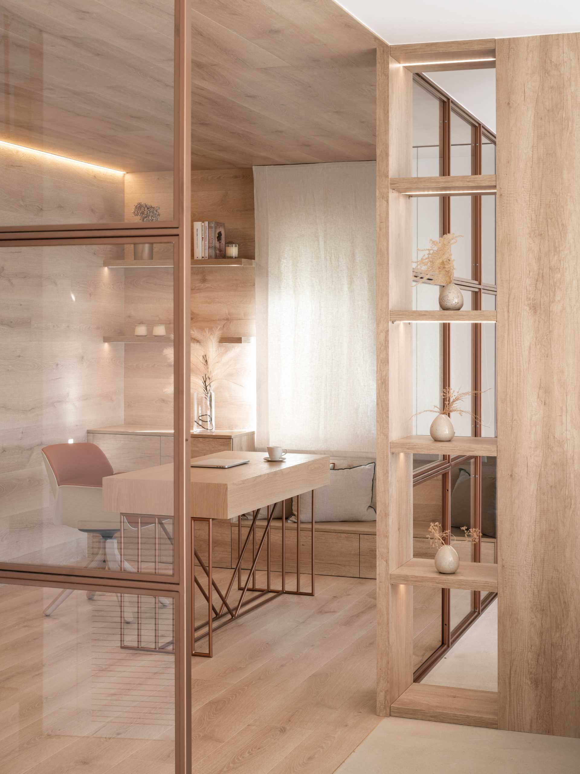 A modern home office, lined with Oak, has copper-framed glass walls that provide views of the living room and kitchen.