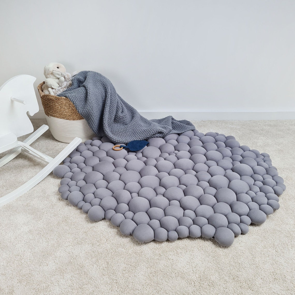 A modern grey rug that would suit a nursery.