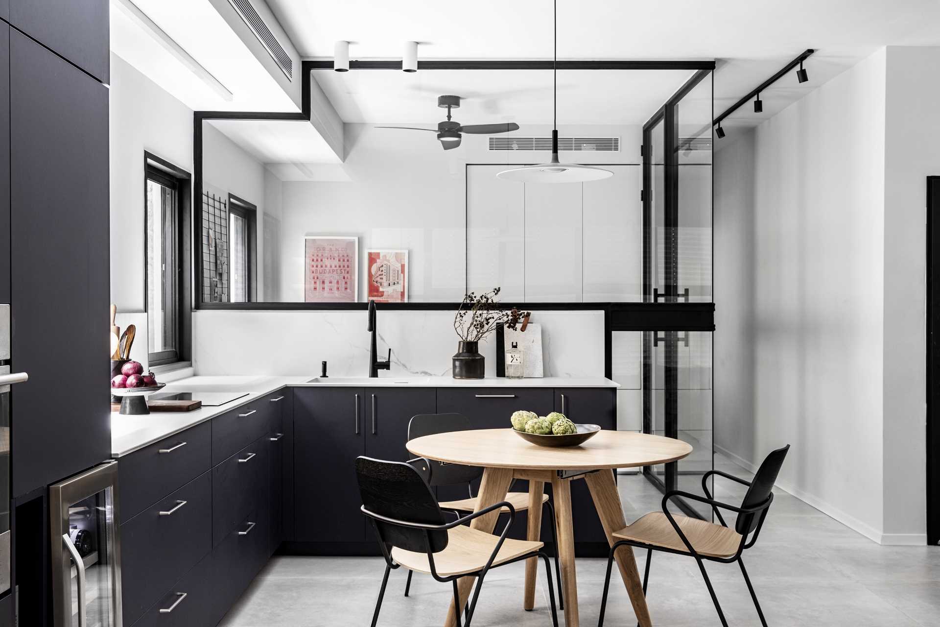Located within the communal space, the home office is tucked away behind glass walls, allowing it to be separated from the open plan living room / kitchen / dining room, but at the same time, still being connected by sight.