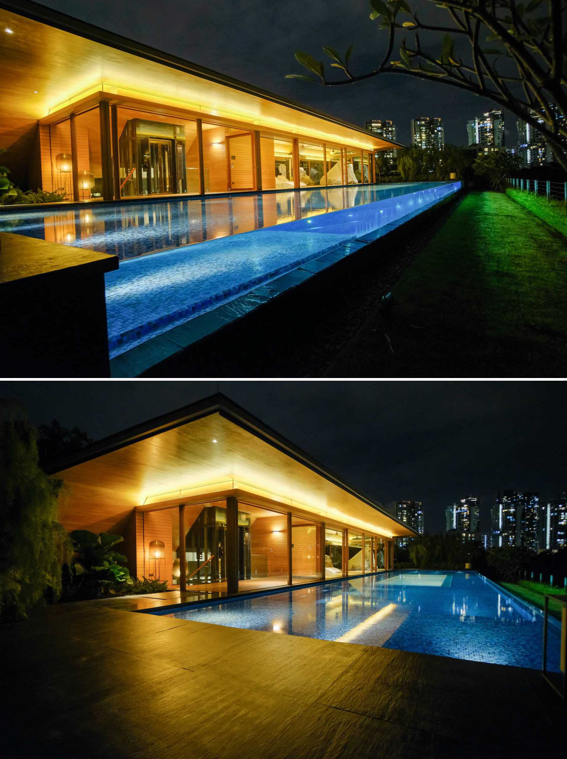 At night, hidden lighting highlights the architectural details of the home, and showcases the see-through wall of the swimming pool.